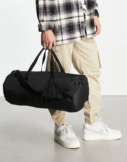 ASOS DESIGN holdall barrel bag in black nylon with contrast puller | ASOS (Global)