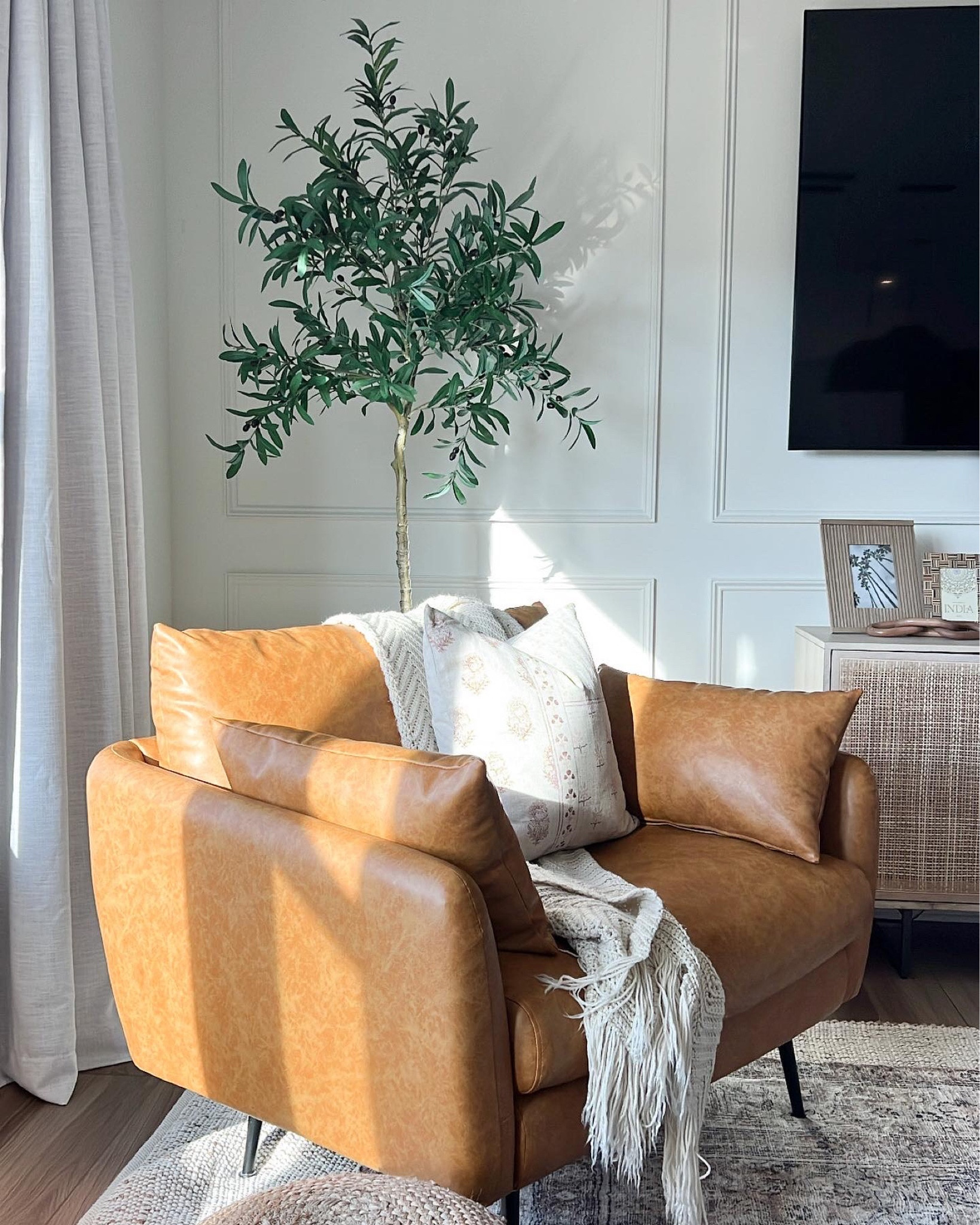 A view I love 🤎

Leather accent chair, spring throw pillow, olive tree, sideboard, wooden picture frame 

#LTKhome