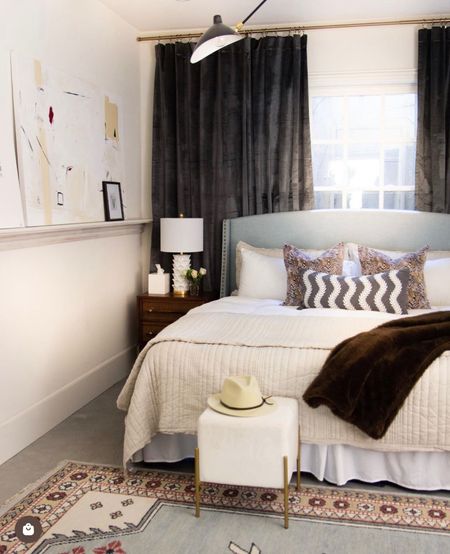 The cozy primary bedroom in my Hedgewood apartment, with gray velvet blackout curtains, beige linen stitched bedding, white leaf table lamps, midcentury cane wicker nightstands, and a light blue curved shelter panel headboard

#LTKFind #LTKstyletip #LTKhome