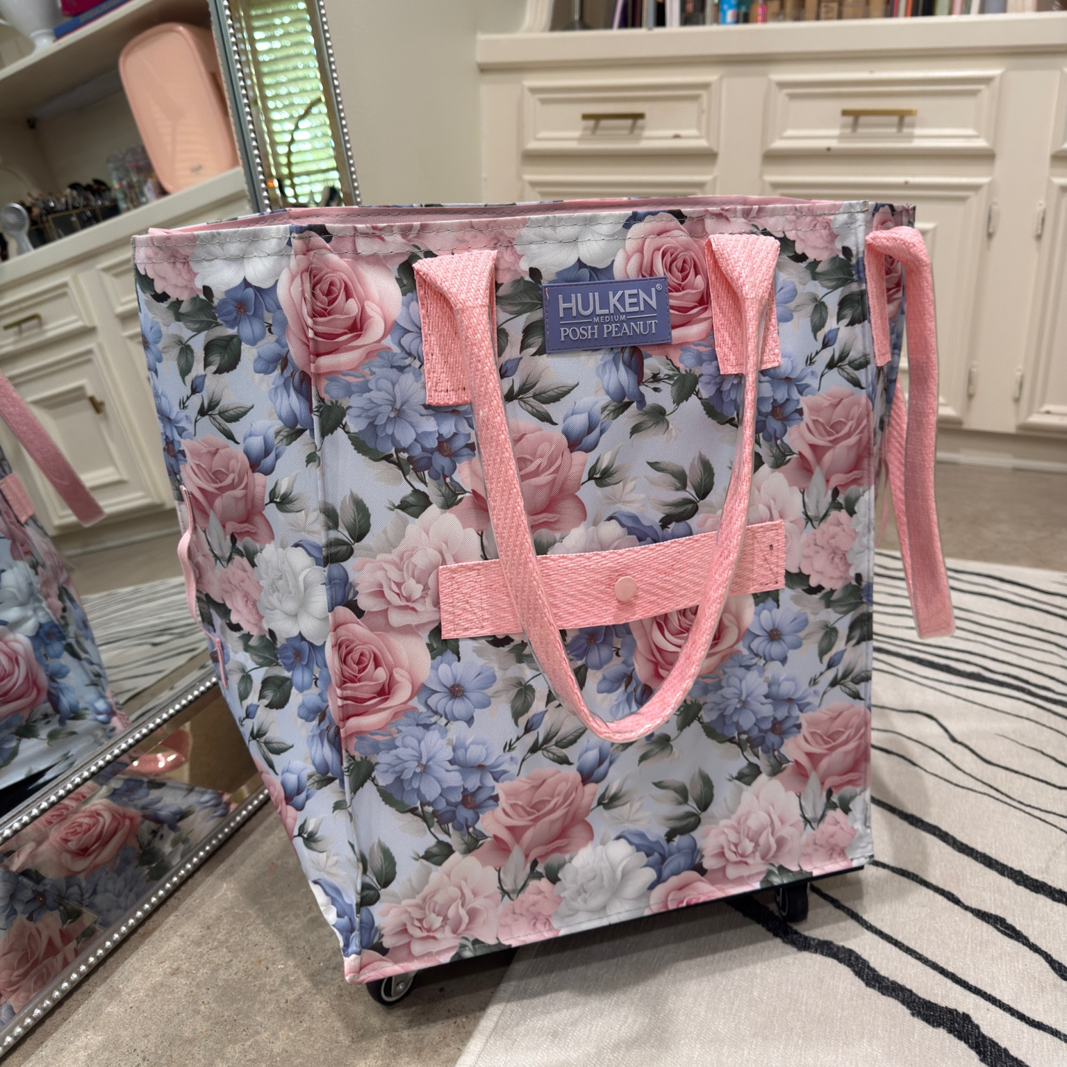 The Hulken bag was already the answer to every "what do I bring to the farmers market / beach day / soccer tournament / weekend trip" question I get. Now it comes in Posh Peanut prints and I genuinely don't know what took so long.The Marion collab is the rolling tote that carries everything — and I mean everything — without looking like a piece of luggage you grabbed from the garage. The Hulken frame is lightweight, the wheels actually roll, and the bag stands up on its own which sounds like a small thing until you've spent ten minutes trying to keep a tote upright in a parking lot.At $130–$145 it's the bag that does real work and looks good doing it. The Posh Peanut print makes it feel intentional rather than utilitarian — which is the whole point. You shouldn't have to choose between a bag that functions and one that reflects your taste. 

 