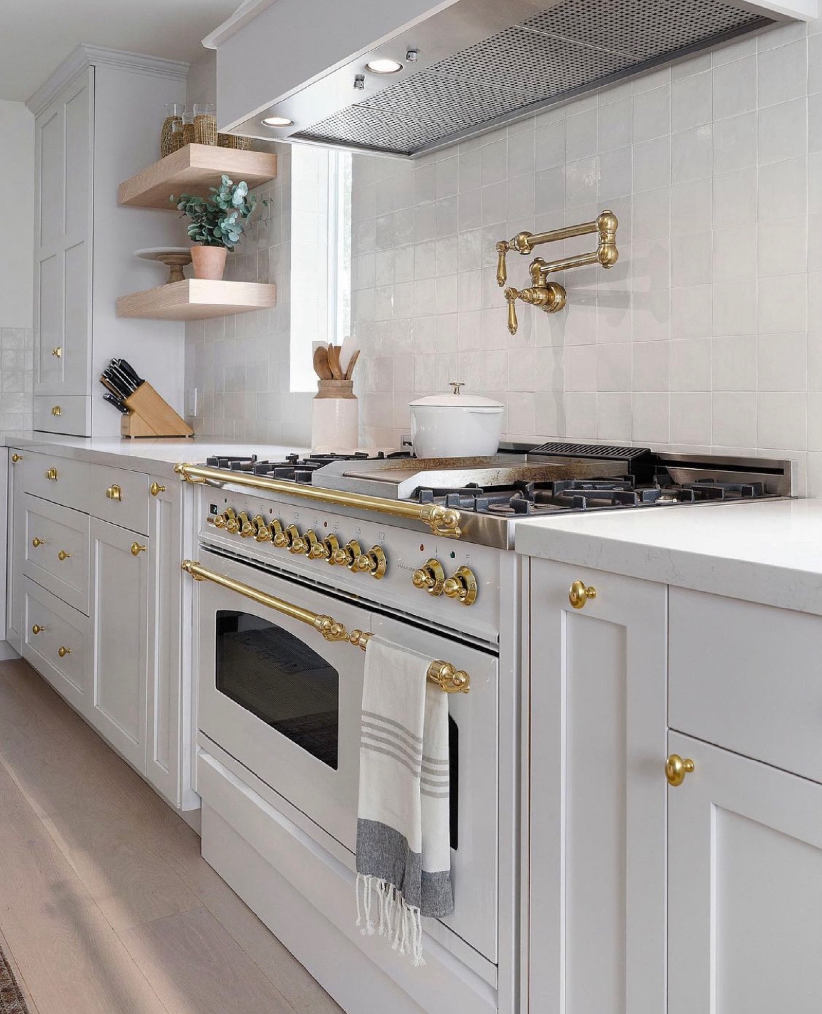 We love our Hallman white range paired with the unlacquered brass pot filler.  Open kitchen shelving is perfect to style your beautiful serving ware.  Kitchen towel is from peonyandolive.com

#LTKMostLoved #LTKhome #LTKstyletip