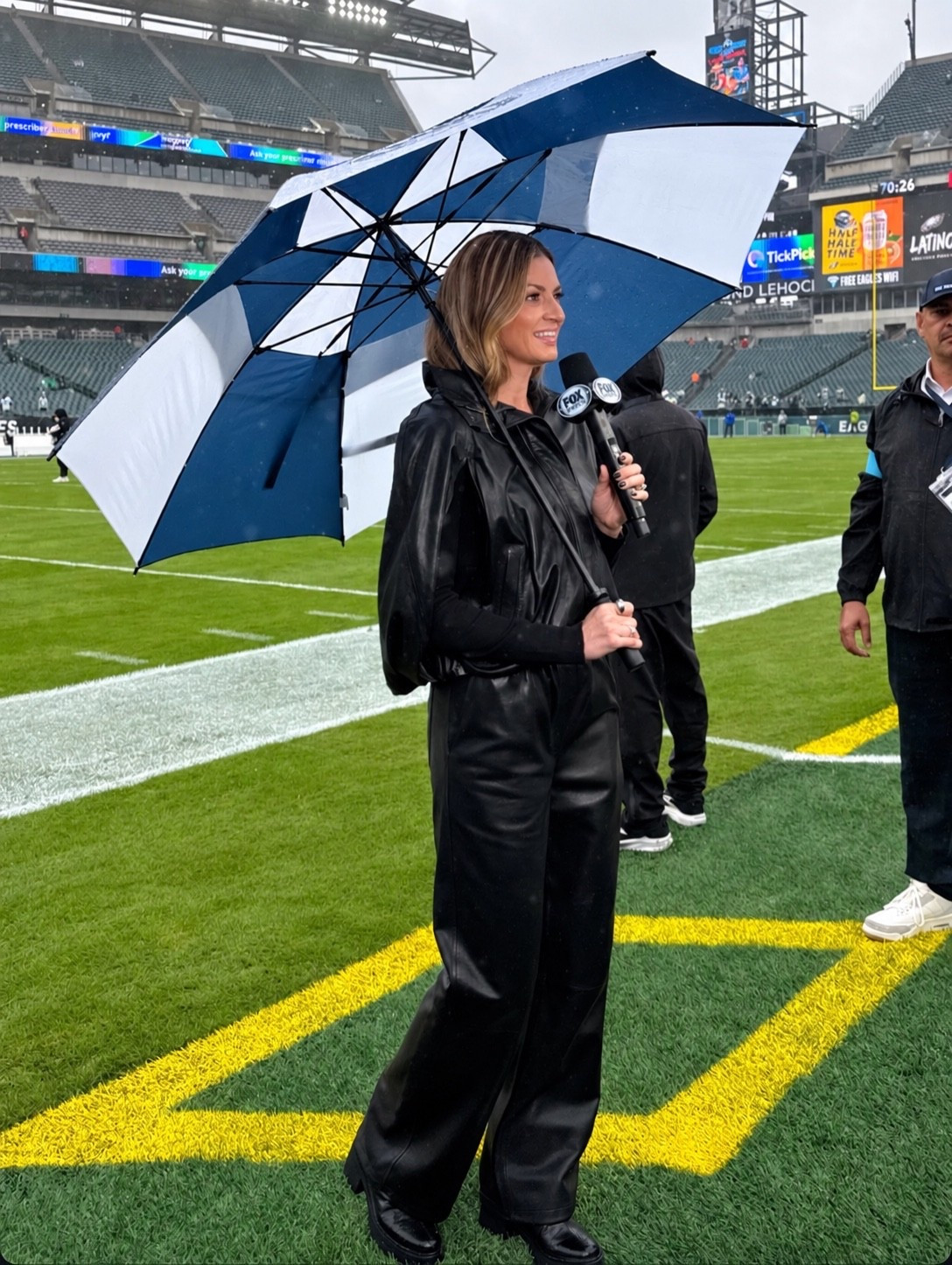 Erin Andrews wearing an all black leather look that includes a must have cape for fall and straight leg leather trousers ￼
