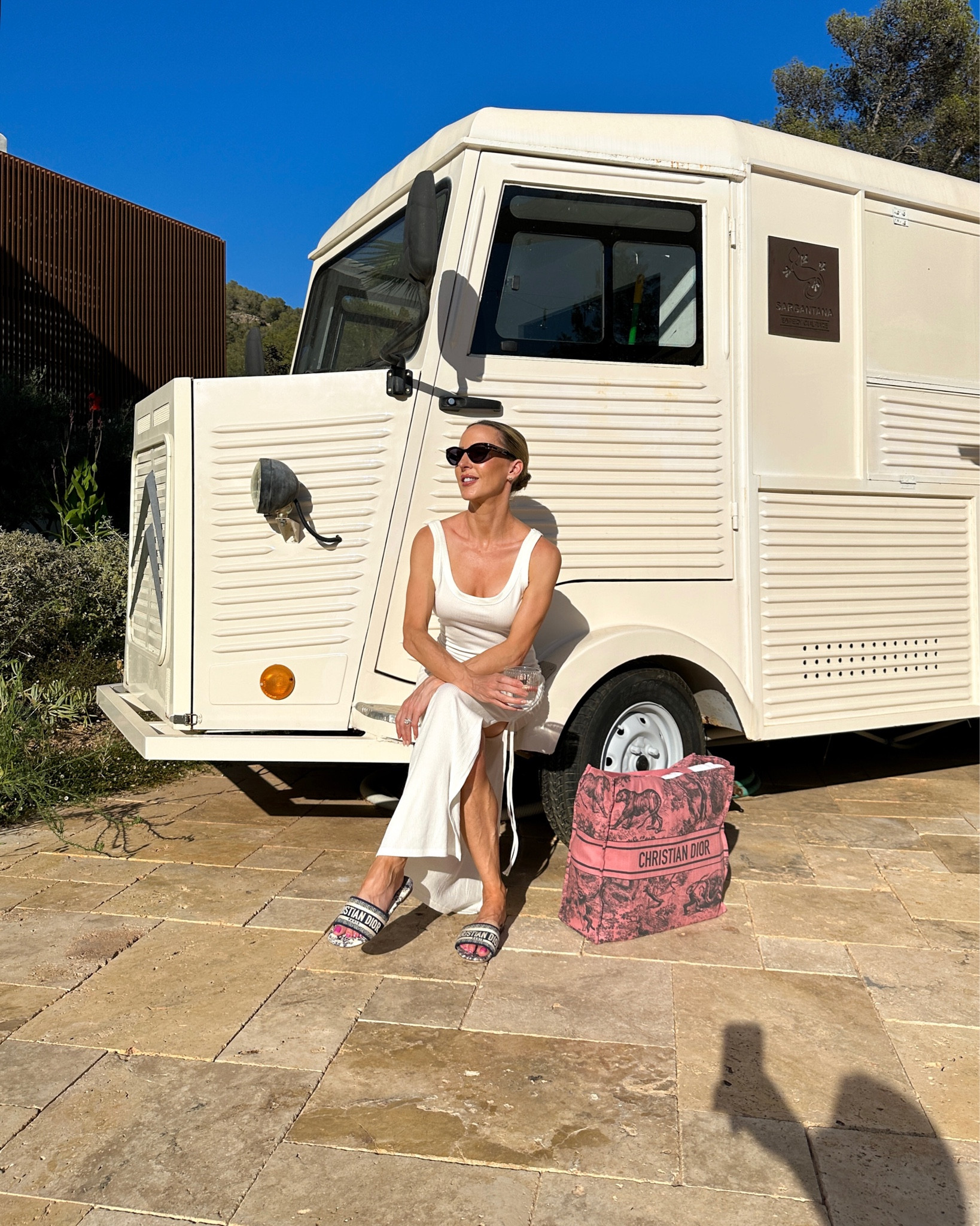 Vacation essentials: White maxi dress, Dior slide sandals, Pink Dior Dioriviera tote bag, Dior tortoiseshell sunglasses.

#LTKshoecrush #LTKSeasonal #LTKtravel