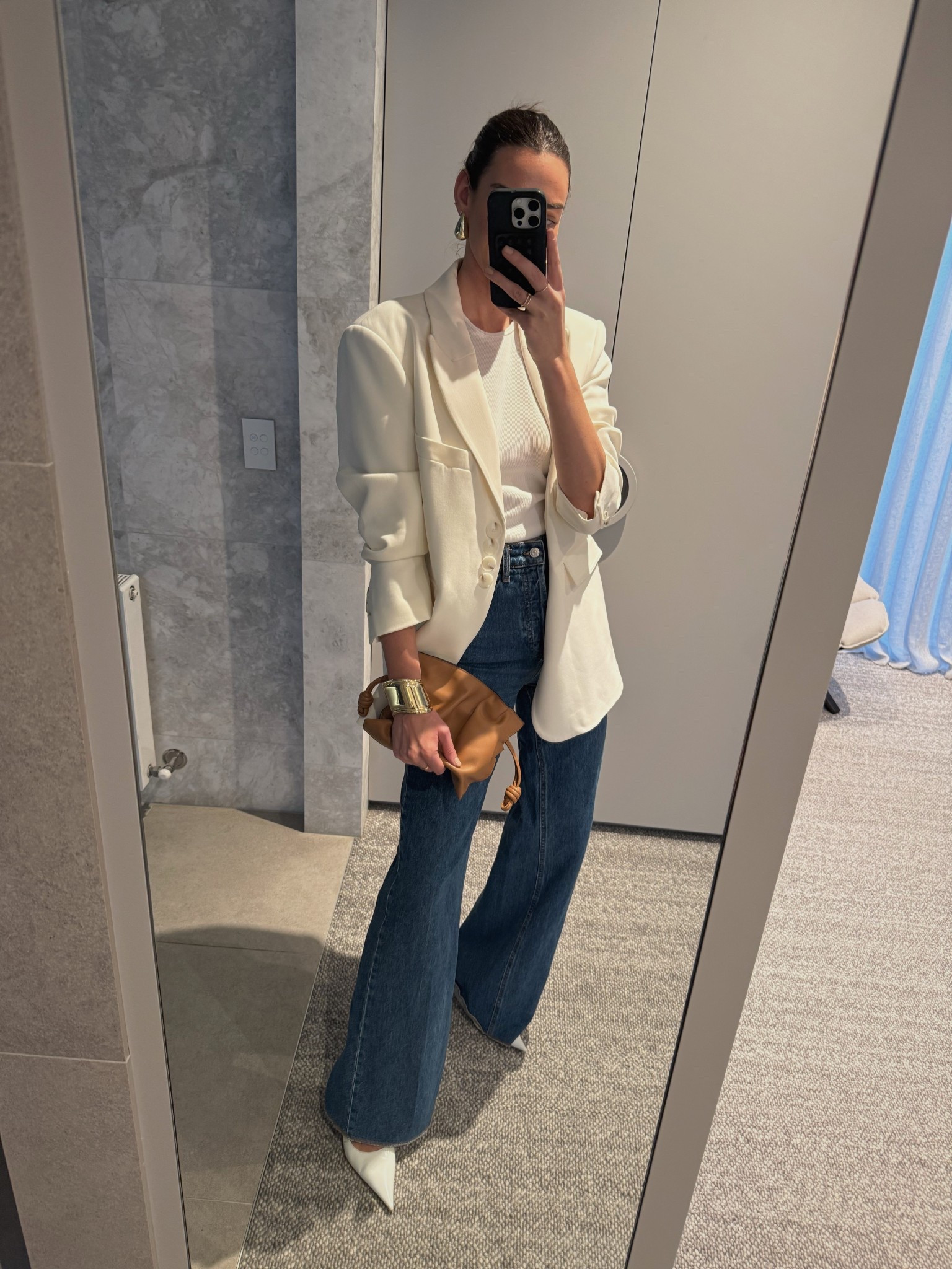 Wardrobe essentials: 
Cream oversized blazer 
High waisted blue flared denim 
Tan Loewe bag 
White pumps 

#LTKaustralia #LTKwinter #LTKstyletip
