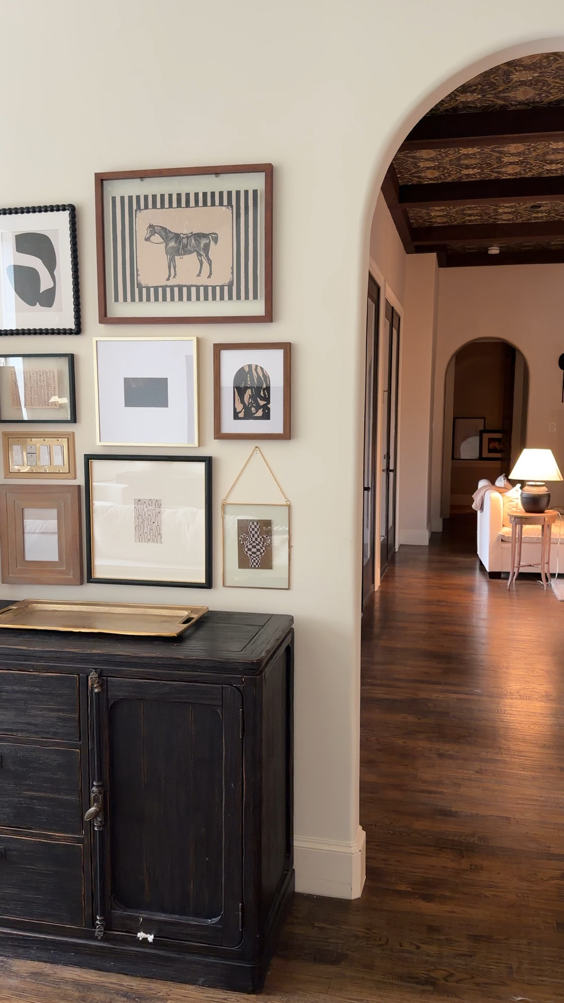 This is your reminder that darker furniture grounds a room beautifully. The contrast against soft walls and layered frames makes everything pop without feeling busy. Linking similar pieces to help you pull this together.

dark wood sideboard, gallery wall inspo, neutral home decor, entryway cabinet, picture frame collage, modern rustic style, living room console decor

#LTKSeasonal #LTKHome