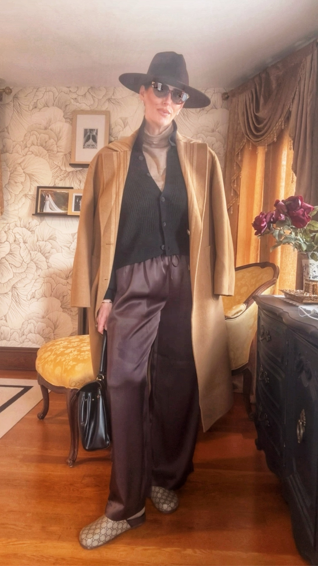 Today’s look is all about cozy chic—the kind of outfit that feels relaxed but still impossibly polished. I layered a soft turtleneck under a ribbed black cardigan for warmth and texture, then added a camel coat to pull everything together in that quiet-luxury way. The satin-finish mocha trousers add just the right amount of drape and movement, and the Gucci slides keep it elevated but comfortable for all-day wear. Finished with a structured black bag and wide-brim hat for that extra touch of intention.

Cozy, neutral, effortless. My favorite kind of styling.

Shop the look:
• Camel coat
• Ribbed black cardigan
• Lightweight turtleneck
• Satin mocha trousers
• Gucci slides
• Black top-handle bag
• Sunglasses + hat

#LTKStyle #CozyChic #QuietLuxuryLook #FallOutfitInspo #NeutralStyle #RealTimeStyling #EverydayOutfit #EffortlessChic #LGStyling

#LTKgrwm #LTKmorningroutine #LTKootd