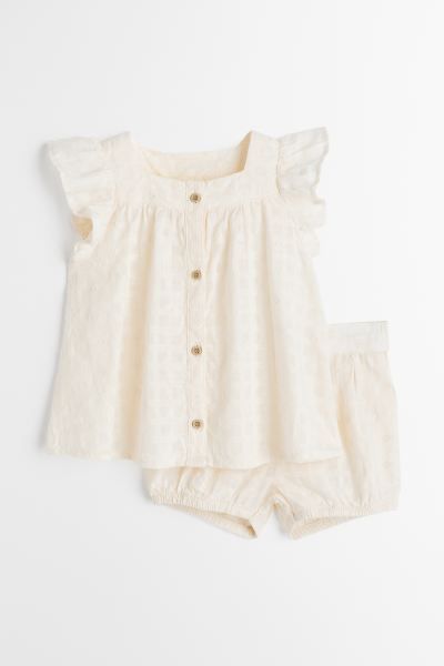 Set with a blouse and shorts in woven cotton fabric with eyelet embroidery. Blouse with buttons a... | H&M (US + CA)