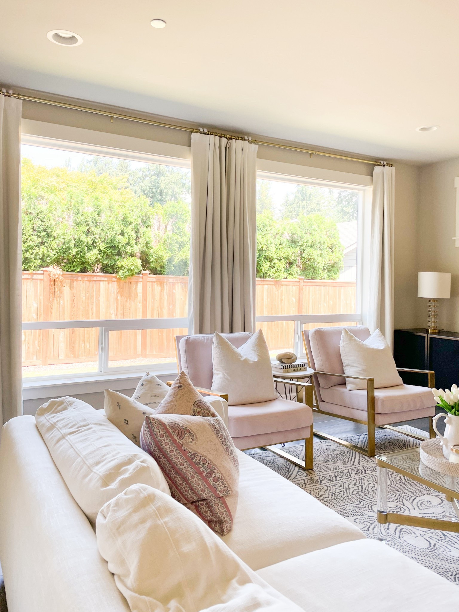 White and black living room, CB2 living room console, acrylic gold coffee table, pink chairs, Minted artwork pink and gold, black and white rug

#LTKHome #LTKSeasonal