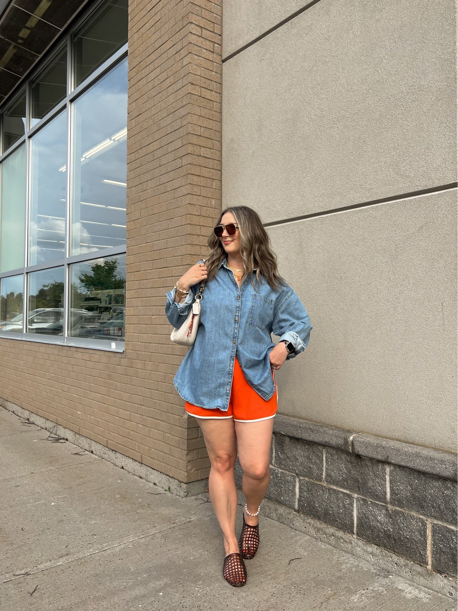 Casual summer outfit! Wearing my usual size L in the red orange dolphin shorts and my fave denim shirt. Jelly shoes are comfy and not sweaty, I’m a 9.5-10 and wear a 10. Canadian shirt and shoes link under “similar products”

#LTKsummer #LTKsale #LTKmidsize
