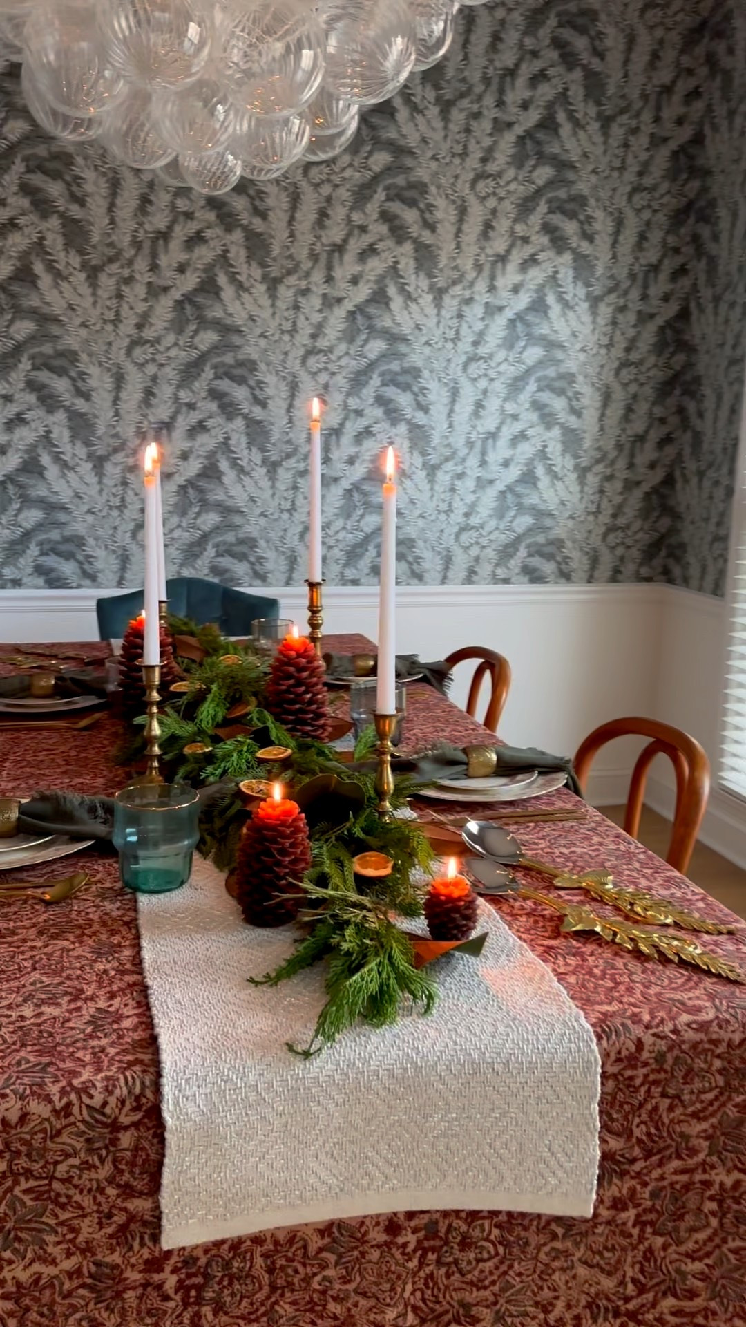 This Thanksgiving table is all about drama and depth — layers of rich color and texture that make dinner feel like an experience. The moody blue floral wallpaper sets the backdrop, while a deep burgundy tablecloth brings contrast and warmth. I layered in a Norfolk real-touch garland, dried oranges, pine cone candles, and brass candlesticks with long tapers for a soft, glowing centerpiece. My gold flatware, striking serving spoons, and dark olive linen napkins add just enough polish. It’s proof that a bold color palette can still feel timeless.

Shop my fall table setting favorites — from the table linens to the candlelight touches.

#ThanksgivingTable #TableSettings #FallDecor #ColorPalettes #BurgundyDecor #MoodyInteriors #HolidayHosting #TablescapeInspo #DiningRoomDecor #LayeredLook #HomeDecorInspo #EntertainingAtHome #InteriorDesign #LTKHome #LTKHoliday #LTKDecor 

#LTKHome #LTKFindsUnder50 #LTKStyleTip
