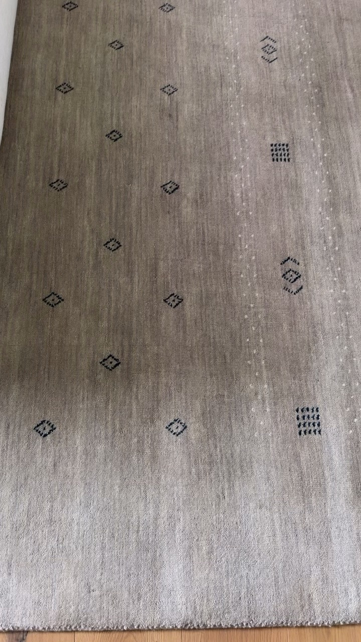 Available in a ton of color options. This is the color Taupe but I also love it in brown. It’s a hand loomed wool rug.