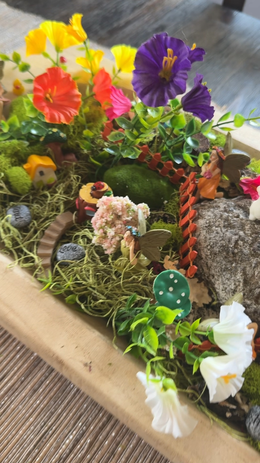 This was such a fun project with my grandkids!  I use this wooden tray/bowl on my table all year and decorate it for each season. This year I decided that we would make it into a fairy village. My grandkids LOVED it. We got fake moss  from Hobby Lobby to fill the bottom. Then I tucked in some faux flowers that I had leftover from last summer. We got a big rock from the yard and then set to work laying out the village. 

It’s a fun project for inside or out!

They had so much fun naming the fairies and setting everything up!  

I can’t link the moss here unfortunately. It comes in a bag with some other artificial fillers as well  

#LTKSeasonal #LTKKids #LTKOver40