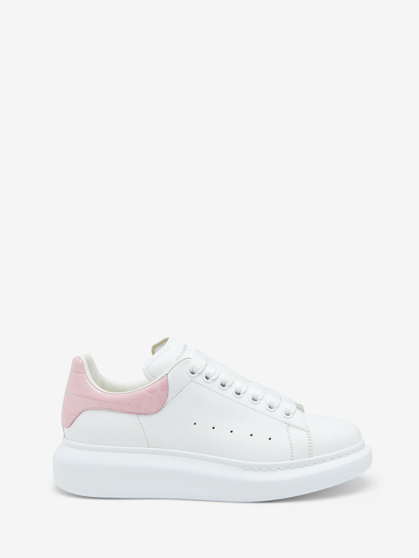 The Oversized Sneaker—statement silhouette in white calf leather, with a pink croc-embossed heel counter featuring the McQueen signature. Finished with a chunky rubber sole. | Alexander McQueen