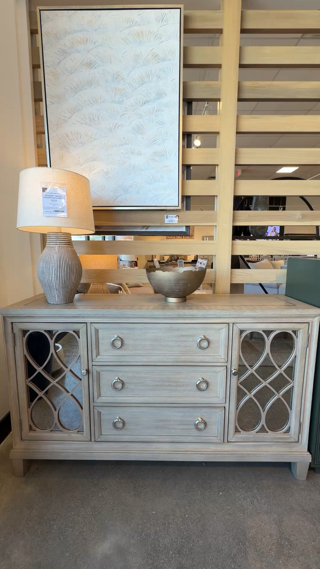 Elegant sideboard with sophisticated details! 🩶 The Jorlaina Dining Server from Ashley Furniture stands out with its antiqued mirror accents, decorative fretwork, and rich gray finish that highlights the natural wood grain. ✨ A beautiful blend of storage and style that adds warmth, character, and a touch of traditional elegance to any space. Linked it here with similar styles! 💫 @Ashley #DiningRoomFurniture #Sideboard #Credenza

#LTKHome #LTKSaleAlert