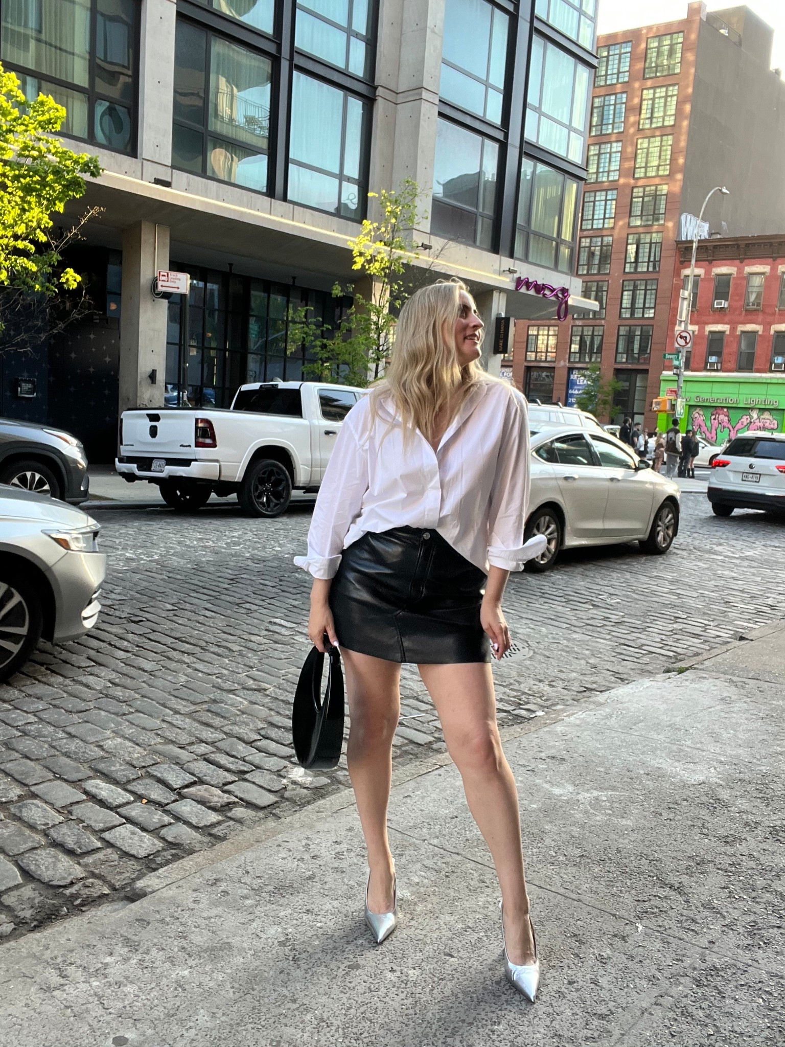 Leather skirt | white button up shirt | silver metallic heels | black purse 