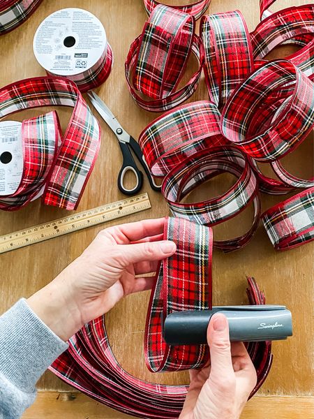Make your own large fluffy bows this holiday season. All the supplies you need to follow our super easy directions to create beautiful Christmas bows on the blog. This classic tartan plaid wired ribbon in white, green and red colors is perfect for the holidays. #Christmascrafts #DIYbows #holidaydecorating


#LTKSeasonal #LTKhome #LTKHoliday