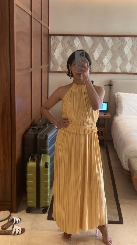 Wore this chic crop pleated halter top and matching pleated maxi skirt to my cousin’s wedding in Cabo. Perfect for the breezy, sunny beach weather. Paired perfectly with ethnic fusion jewelry from JCrew for a modern twist on tradition. Wore heels because the event was on the terrace. #HaldiStyle #FusionFashion #weddingguestoutfit #haldigueststyle 

#LTKOver40 #LTKStyleTip #LTKWedding