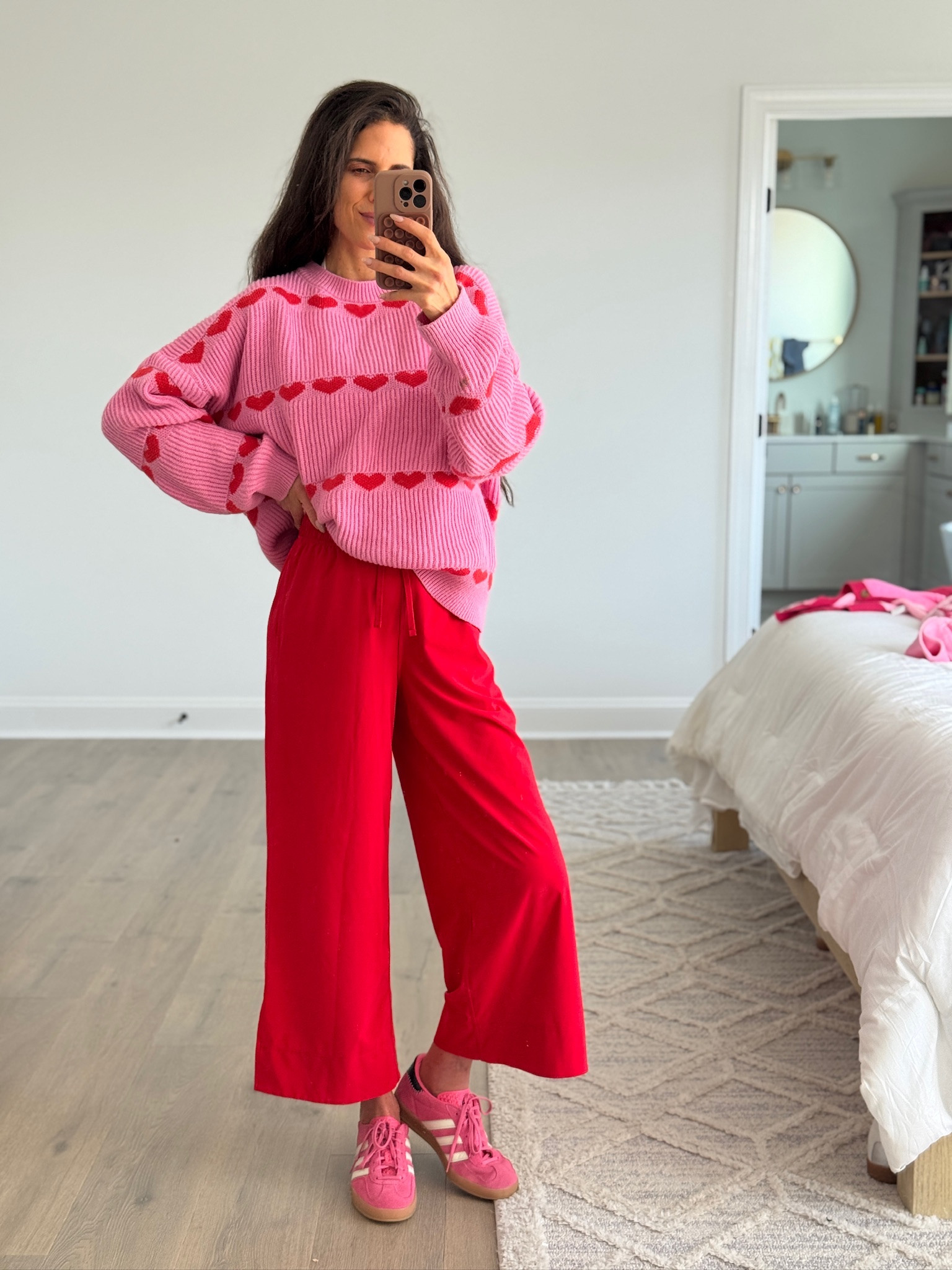 Fun, cozy outfit with a playful pop of color. Soft oversized heart sweater styled with flowy wide-leg pants and casual sneakers for an easy, comfortable everyday look. Perfect for running errands, casual outings, or days when you want something relaxed but still fun. A great way to mix color into an everyday wardrobe.

Casual outfit, everyday outfit, heart sweater, pink sweater, red pants outfit, wide leg pants, comfy outfit, casual chic style, playful outfit, mom outfit, affordable fashion

#LTKootd #LTKmomlife #LTKSeasonal