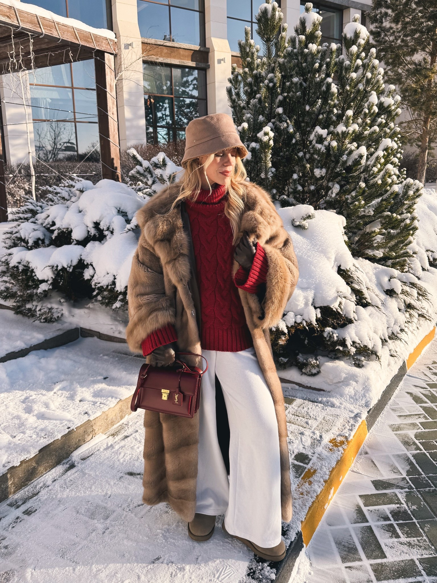 Cozy winter travel look, oversized fur coat, shearling bucket hat, red cable knit sweater, white wide leg joggers, Ugg mini boots, red and cream outfit 

#LTKHoliday #LTKFindsUnder50 #LTKTravel