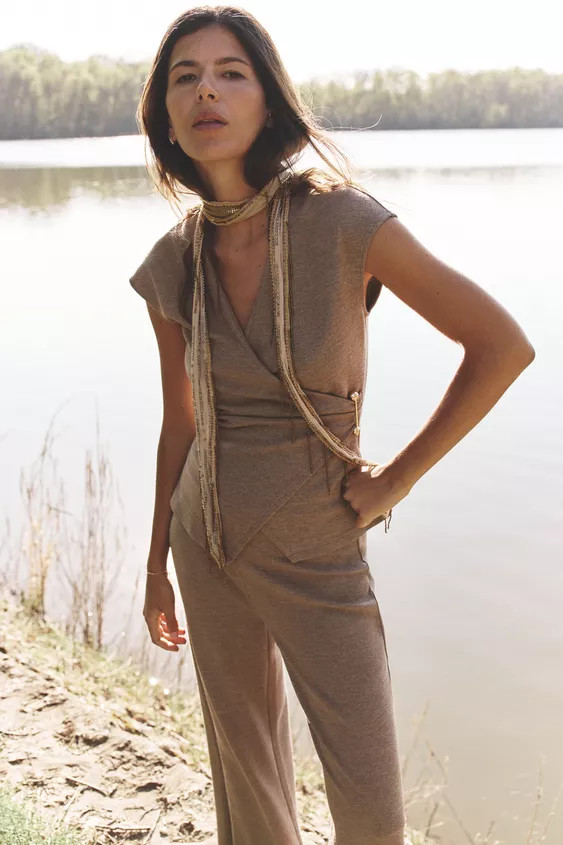 Surplice V-neck top with dropped armholes. Textured fabric and side metal clasp detail. Asymmetri... | Zara US