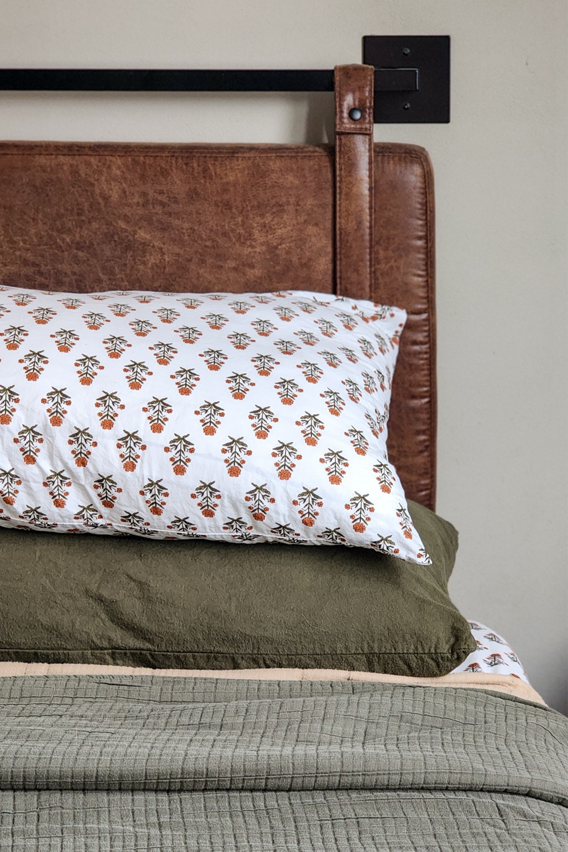 I’ve been trying to be better about making our bed every day, and while I’m still in the “what’s the point because I’m just getting back in it in 12 hours” call, I do enjoy getting into a made bed at night.

Brown faux leather wall mount hanging headboard, block print Target Threshold organic percale bed sheets, army green ultra soft flannel pillowcases, Threshold designed by Studio McGee & Co. waffle blanket on camel, textured coverlet.

#LTKHome