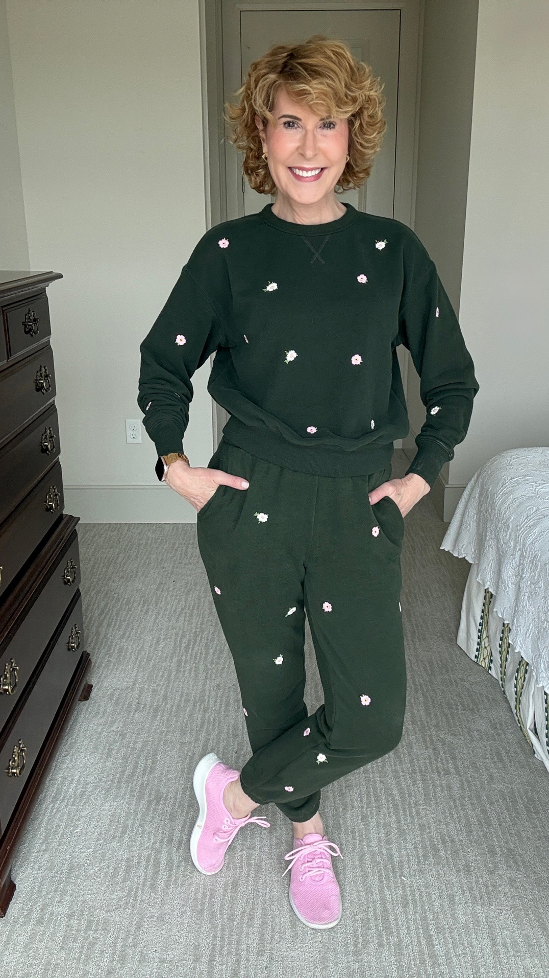 Dark green floral embroidered sweatsuit with a matching sweatshirt and joggers, styled with pink sneakers for a cute, casual pop of color. An easy fall athleisure outfit for travel, errands, lounging, or everyday wear, with cozy matching-set style and feminine floral details.

#LTKootd #LTKOver40 #LTKSeasonal