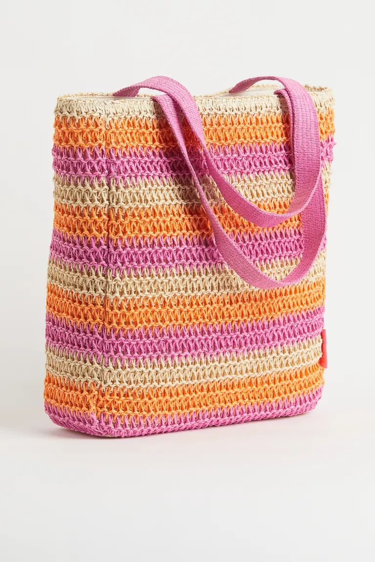 Lined, crochet-look bag in braided paper straw with two handles at top. Depth 4 in. Width 13 1/2 ... | H&M (US + CA)