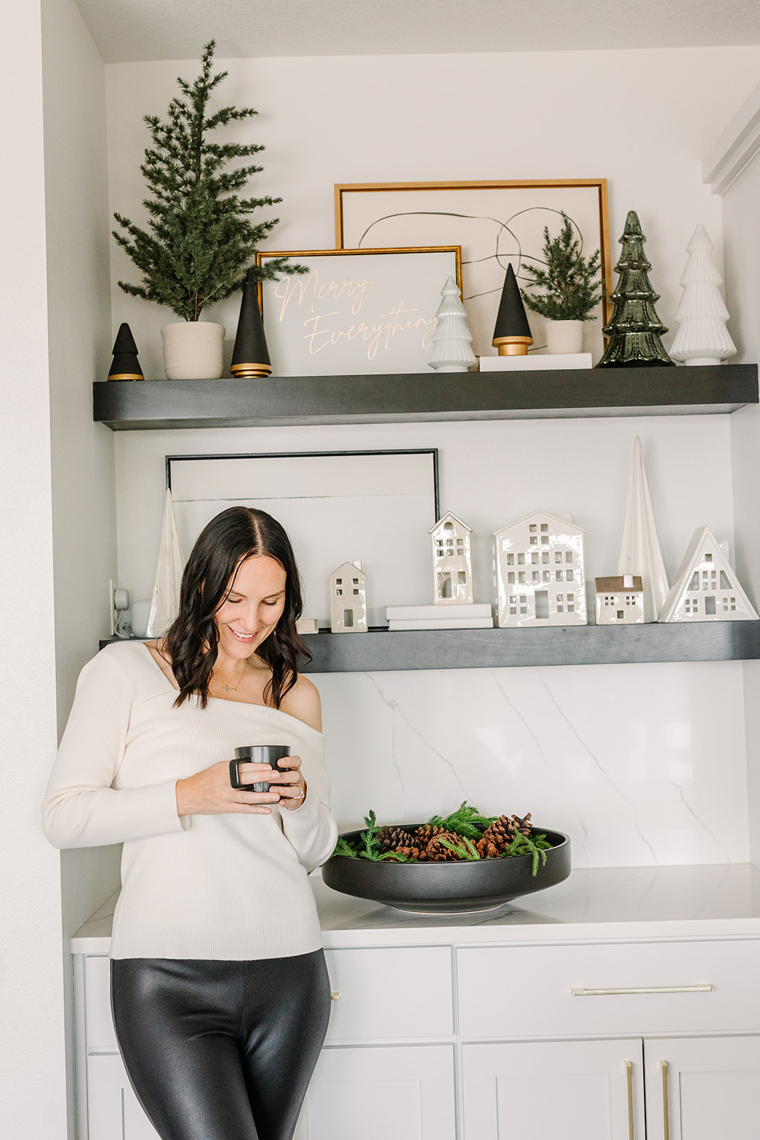 My Christmas shelves—white village houses and greenery making the coziest little moment 🎄🤍  

 

#LTKHoliday #LTKHome