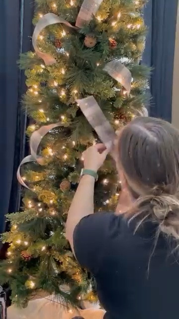 It really is that easy! And it looks amazing! You can add ribbon to a skinny or regular Christmas tree using this method. Happy decorating! #christmastree #christmasdecorating #christmastreedecorating