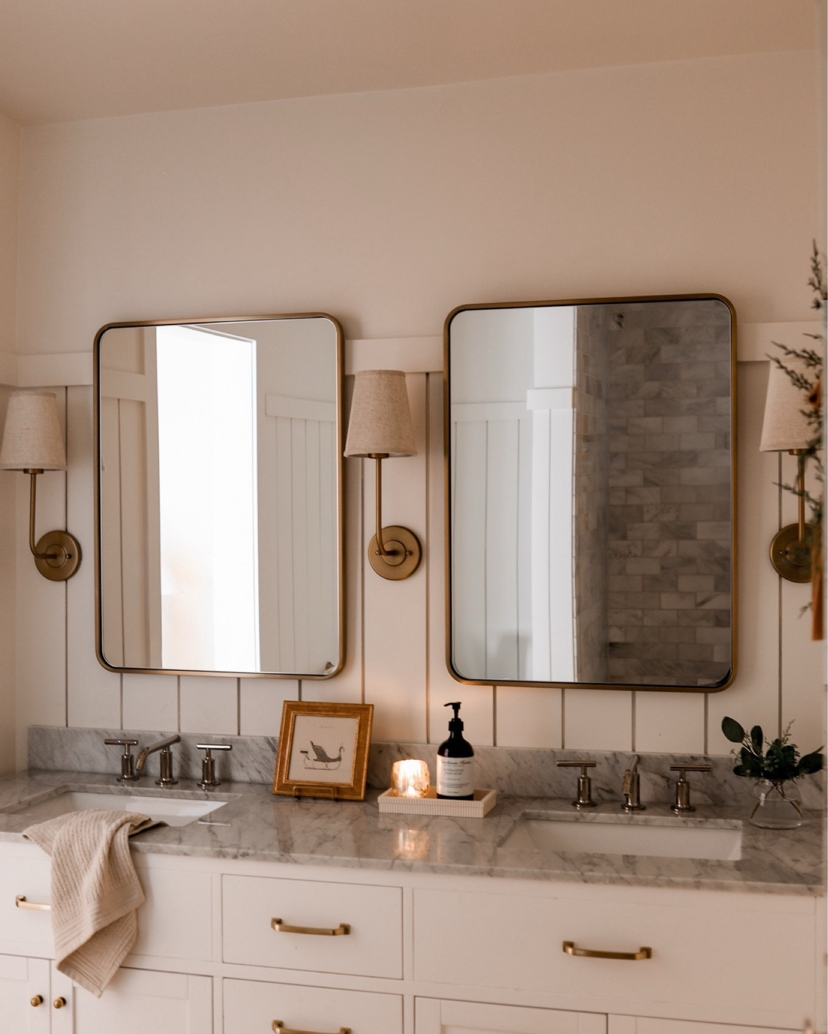 
During our recent renovation, I gave our bathroom a refresh with three simple but thoughtful changes. I painted the paneling a soft shade of Swiss Coffee, added rounded rectangle mirrors above the vanity, and replaced the lighting with these chic but affordable linen shade sconces. These subtle upgrades transformed the space, making it feel fresh and elevated! 

#neutral #cozy #hygge #guest #art

#LTKSaleAlert #LTKFindsUnder100 #LTKHome