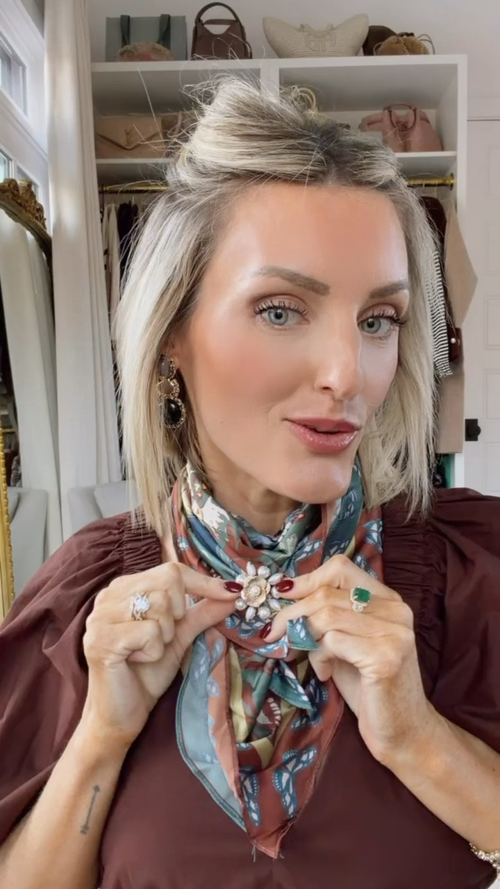 Another way to style a scarf is to add a broach to it! I loved this gold and pearl one that looks like a flower! I just pinned it where the corner ends of the scarf were, and it just adds a jewel piece to the scarf, which I think is really fun!

Loverly Grey, Anthropologie, silk scarf, satin scarf, ways to wear a scarf, broach, accessories 

#LTKFindsUnder50