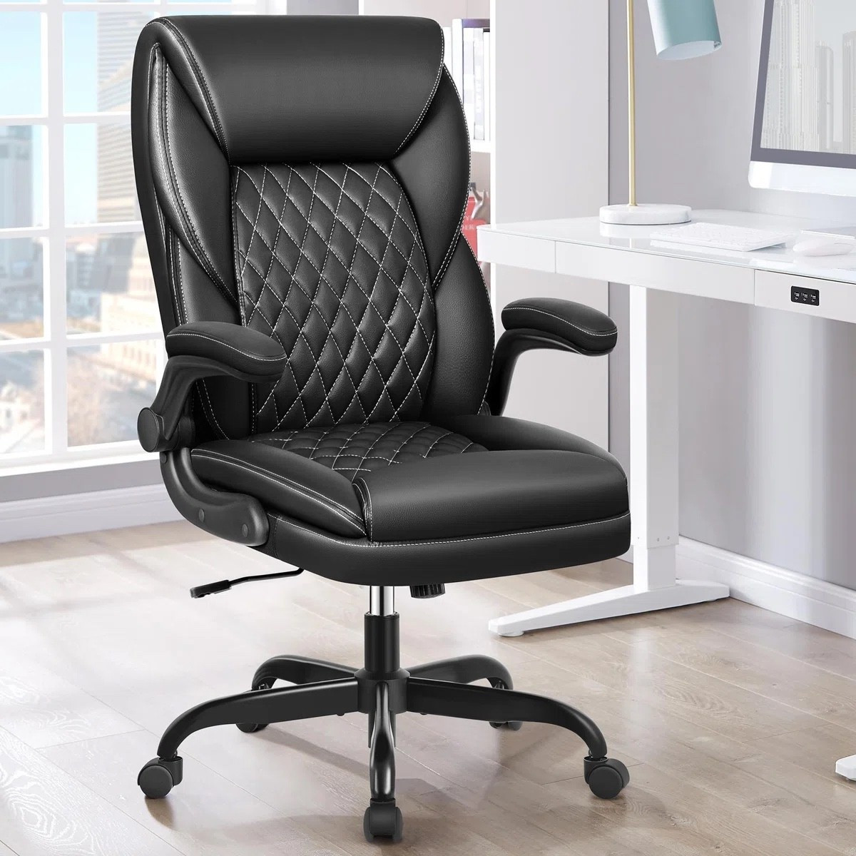 Upgrade your home office with this ergonomic leather office chair from Wayfair, currently part of the Warehouse Clearout and 53% off. Featuring flip-up armrests, plush cushioning, diamond-quilted detailing, and a high-back design, this desk chair combines comfort and style for long workdays. Perfect for remote work, study spaces, and executive home offices.