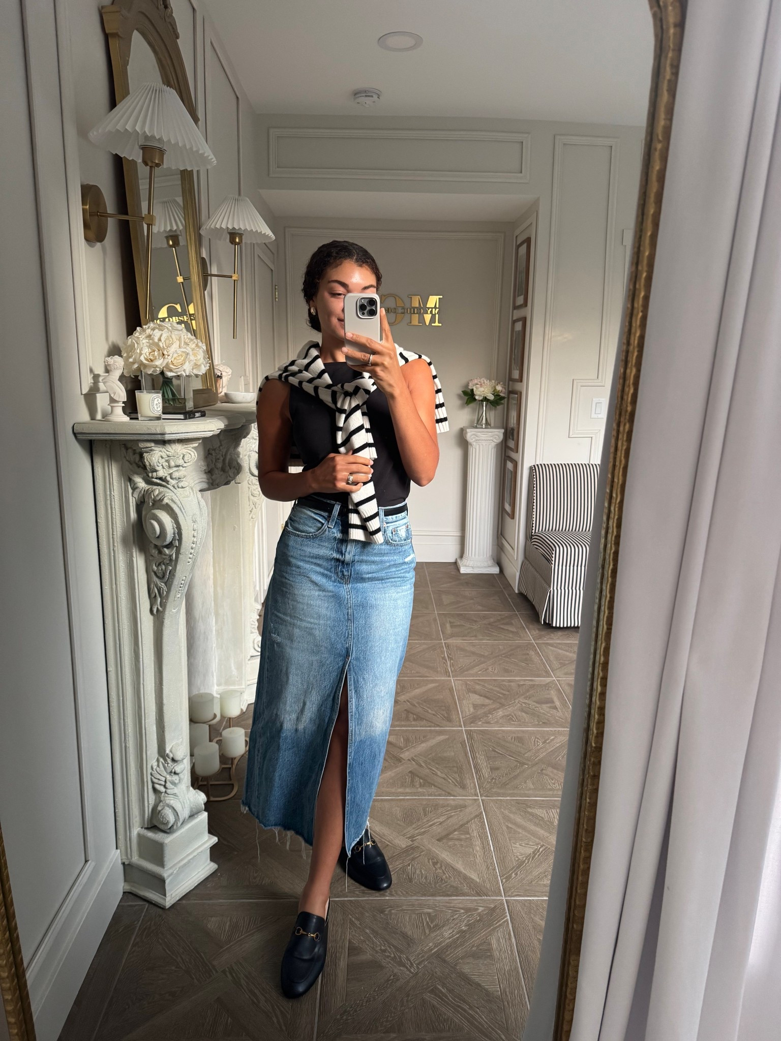 Early fall/hot fall outfit: black tank top, midi denim skirt, mules, belt, and a sweater draped around your shoulders for later 

#LTKFindsUnder100 #LTKSeasonal #LTKStyleTip