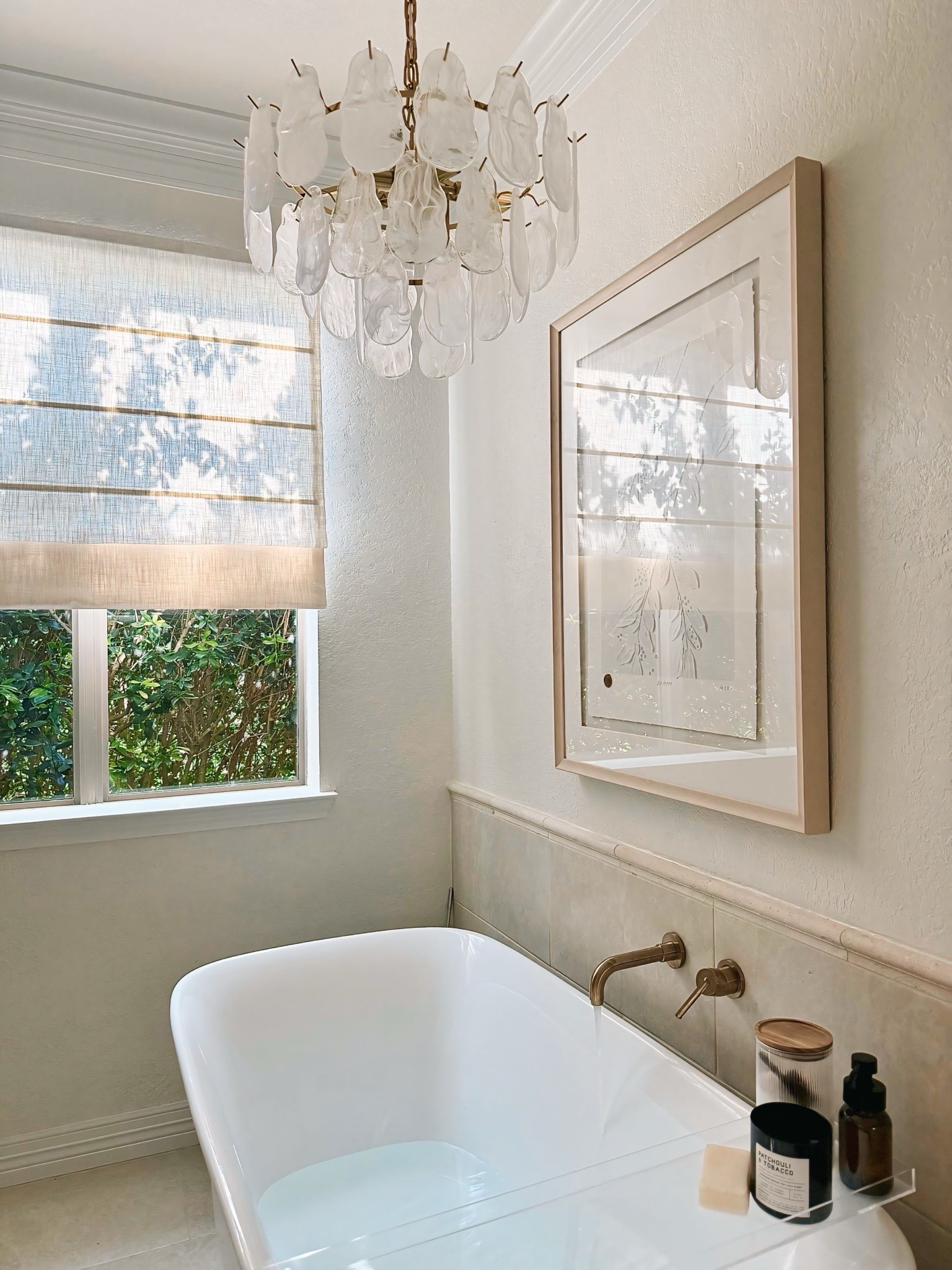 Bathroom glow-up ✨ Loving the soft glam vibe in our newly remodeled space — from the two-tone Roman shade to the acrylic bath tray and chandelier moment above the tub. Proof that even the smallest details can elevate your everyday. 💫 

#LTKHome #LTKFindsUnder100 #LTKStyleTip