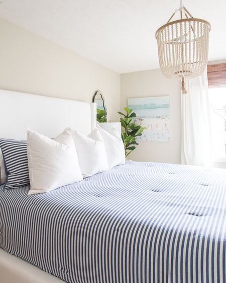 Our previous guest bedroom decor includes a beachy abstract art, faux fiddle leaf fig, an upholstered bed, a blue and white striped comforter, white pillows, striped throw pillows, a ceramic table lamp and a wood beaded chandelier, a beveled frameless mirror, linen blackout curtains  

simple decor, bedroom decor, fiddle leaf fig tree, bedroom lighting, bedroom mirror, guest bedroom inspiration, area rug, target chair, amazon home decor, master bedroom decor, pottery barn bed, pottery barn inspired room, coastal bedroom, bedroom bedding, abstract art, canvas wall art, classic design, simple decorating, target style, abstract wall art, bedroom rugs, guest bedroom décor, target home décor, amazon finds, serena and lily bedding, master bedroom, guest bedroom, bedroom decorating #ltkfamily #ltkfind 

#LTKSeasonal #LTKstyletip #LTKunder50 #LTKunder100 #LTKhome #LTKsalealert #LTKstyletip #LTKhome #LTKsalealert