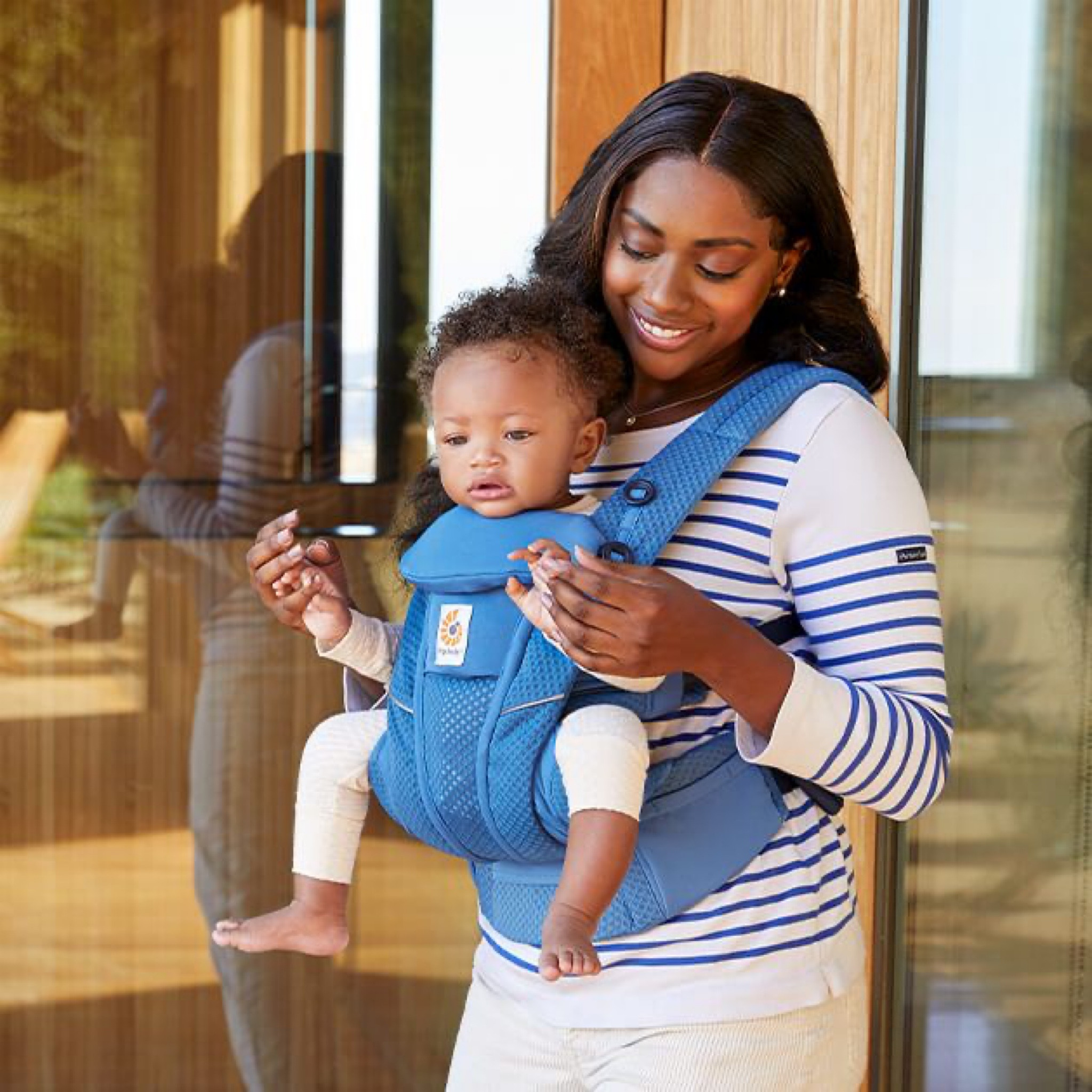 Mom rocks a white and blue mariner striped top with a matching blue baby carrier, embracing effortless style.

#LTKFamily #LTKBaby #LTKKids