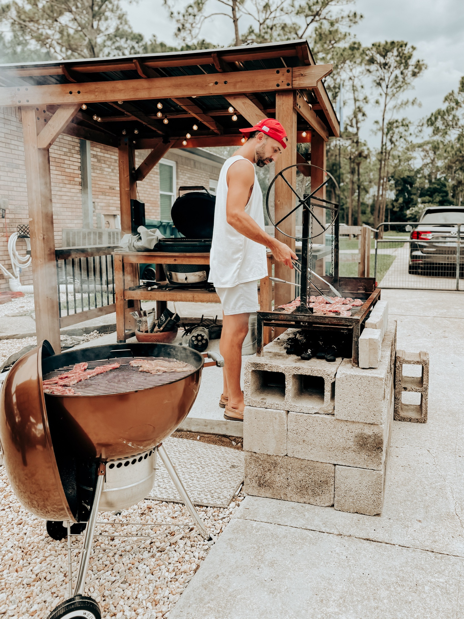 My husband, Will, and his grills. 

We call this area Will’s Grills and the Santa Maria grill will eventually be prettier and permanent but it works for now.

Anywho, the grill pergola is from Sam’s Club and serves nicely as a protector of the Big Green Egg! 

The Weber is always a classic and the Santa Maria grill really brings out his Argentine heritage. 🇦🇷 

Everything that comes from this grilling department is delicious. Every. Time. 

#summer #bbq #outdoors 

#LTKSeasonal #LTKMens #LTKHome