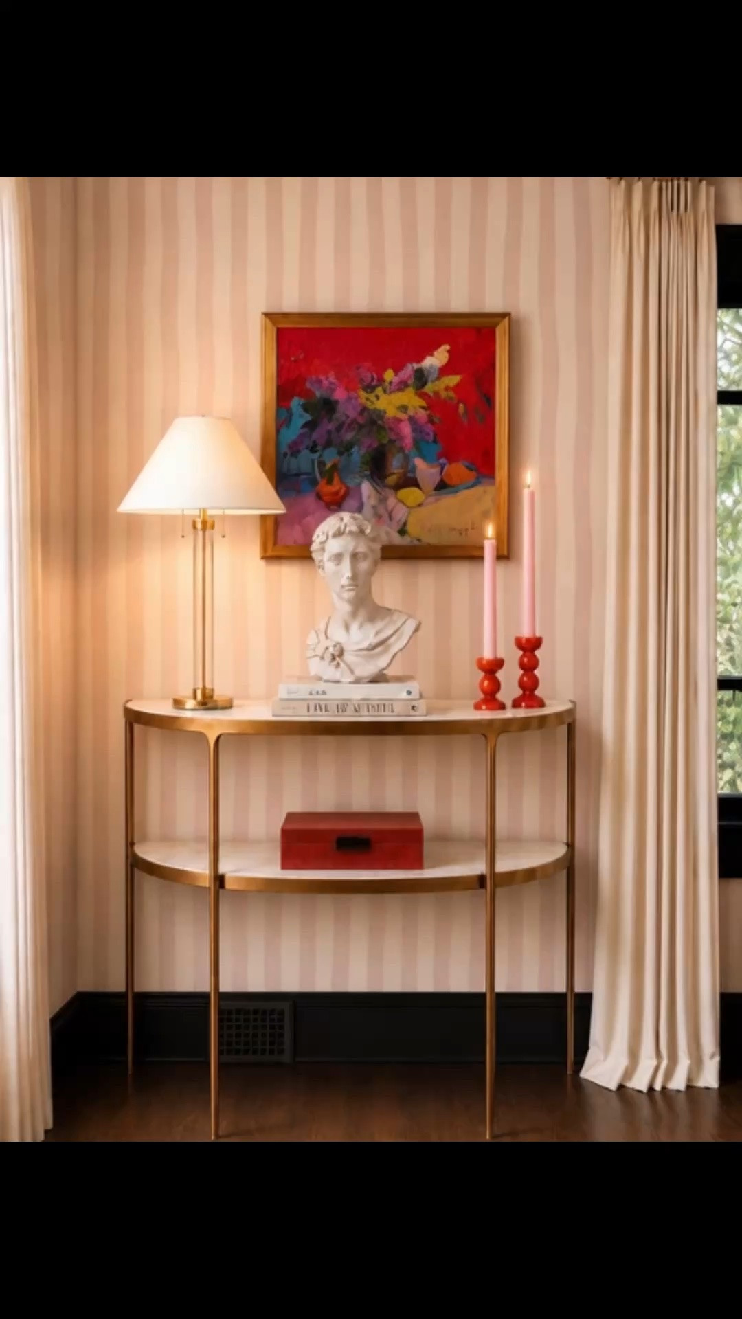 There’s something so comforting about coming home in the evening and turning on a beautiful table lamp. The warm glow, softly flickering candles, and artwork you love instantly make the entire home feel more welcoming.

This thoughtfully styled vignette could live in an entryway, living room, or hallway—anywhere you want to create a moment that feels elegant, collected, and personal. The striped wallpaper adds personality, while the modern classic console, timeless sculpture, and statement candle holders bring every layer together.

Not every corner needs a hard function. Sometimes its purpose is simply to make coming home feel beautiful.

#stripedwallpaper #wallpaper #consoletable #entrywaydecor #vignette #homedecor #modernclassic #artwork #tablelamp #sculpture #candleholder #interiordesign #entrywaystyling #homedetails #luxuryhome #eveningathome

#LTKdayinmylife #LTKHome

#LTKootd #LTKHome