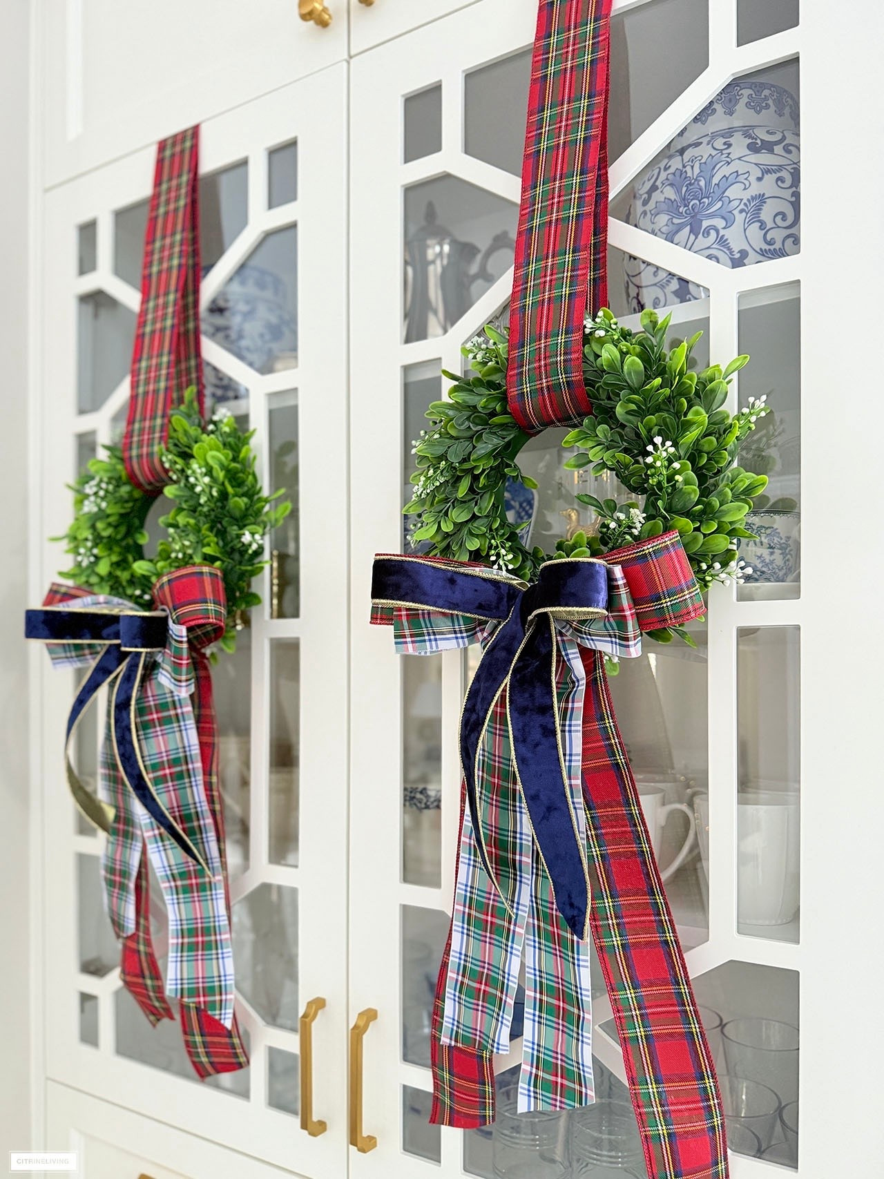 The prettiest Christmas wreaths! Simply hang your wreath with ribbon taped on the inside of your cabinet, and dress it up with beautiful layered bows!

#LTKHoliday #LTKHome #LTKSeasonal