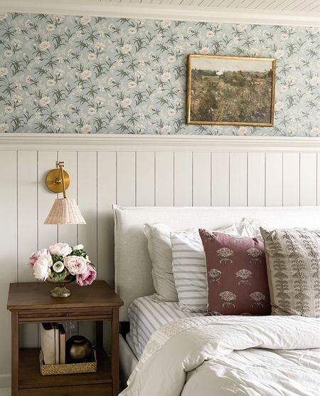 Guest bedroom details: floral wallpaper, over the bed landscape art, upholstered bed, woven sconce, classic nightstand, peony arrangement



#LTKhome