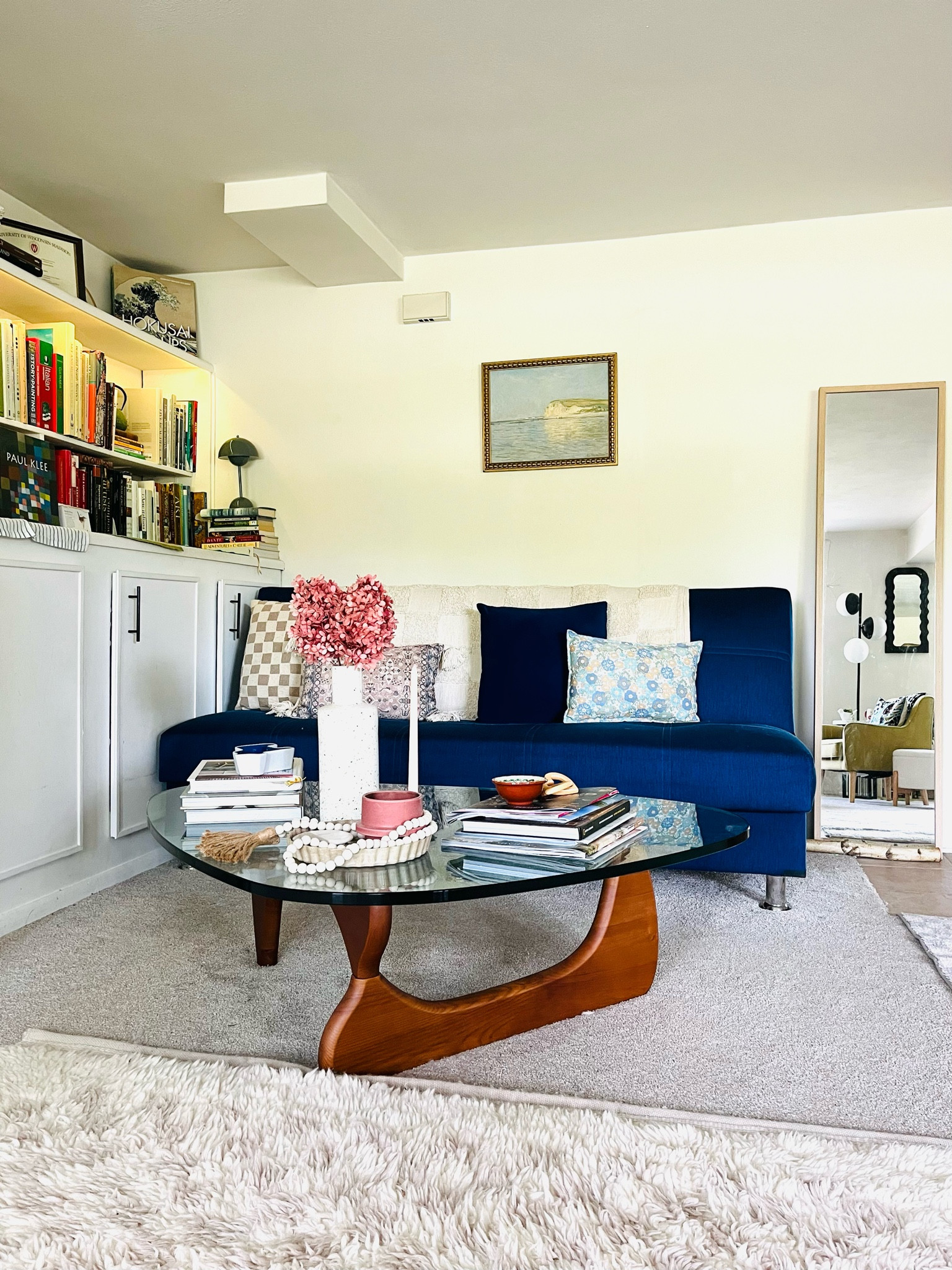 June views from my living room! I love this very affordable Monet painting, it is perfect for the summer! Noguchi style coffee table, globe floor lamp, curvy mirror, Pantone lamp and a wool checkered rug from West Elm! Living room design | living room decor | styling | decorating | living room ideas 

#LTKStyleTip #LTKSeasonal #LTKHome