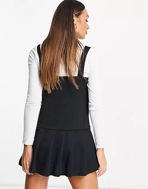 ASOS DESIGN 2-in-1 pleated black pinny dress with white long sleeve top | ASOS (Global)