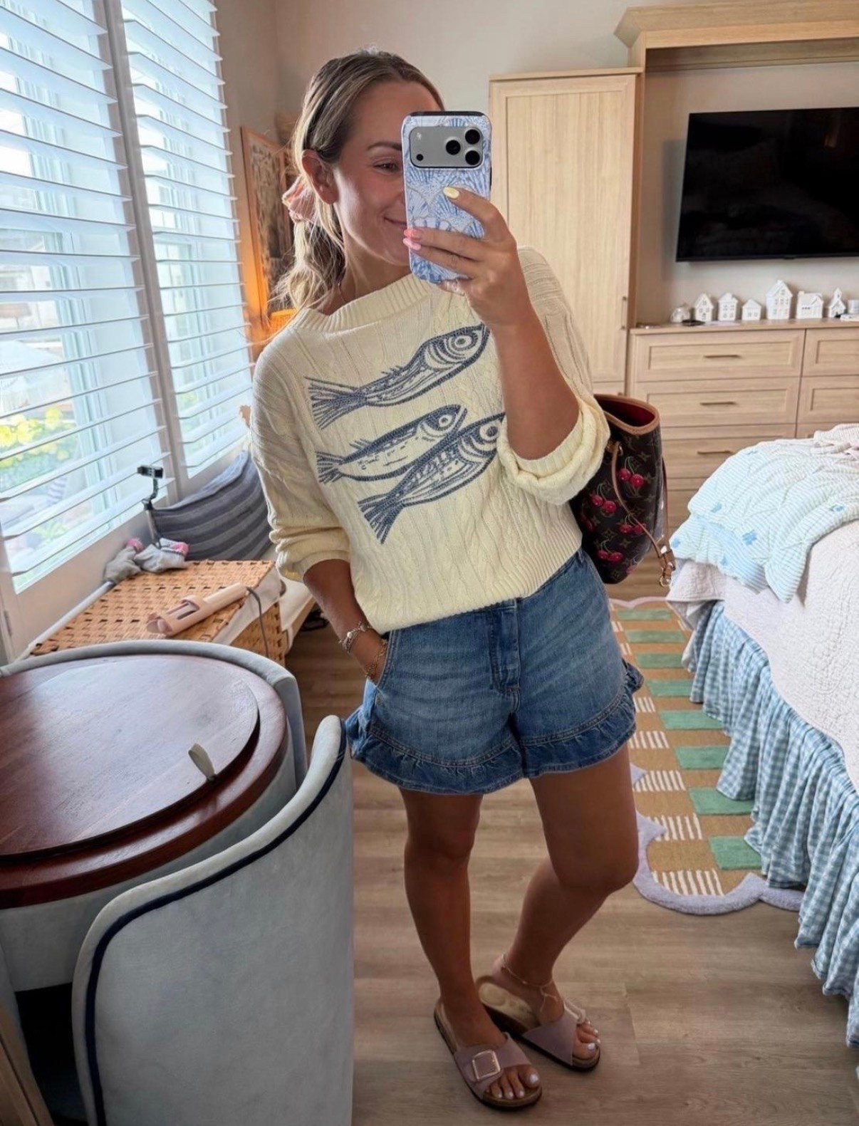 Current coastal uniform. ⚓️

This fish sweater had me at first scroll. Paired it with my favorite ruffle denim shorts and comfy buckle sandals for an easy summer outfit that works for coffee runs, beach towns, errands, or dinner by the water.

fish sweater, coastal style, coastal grandmother, summer sweater, lightweight knit, denim ruffle shorts, high waisted shorts, casual summer outfit, beach vacation outfit, seaside style, nautical fashion, neutral outfit, everyday summer look, buckle sandals, vacation style.