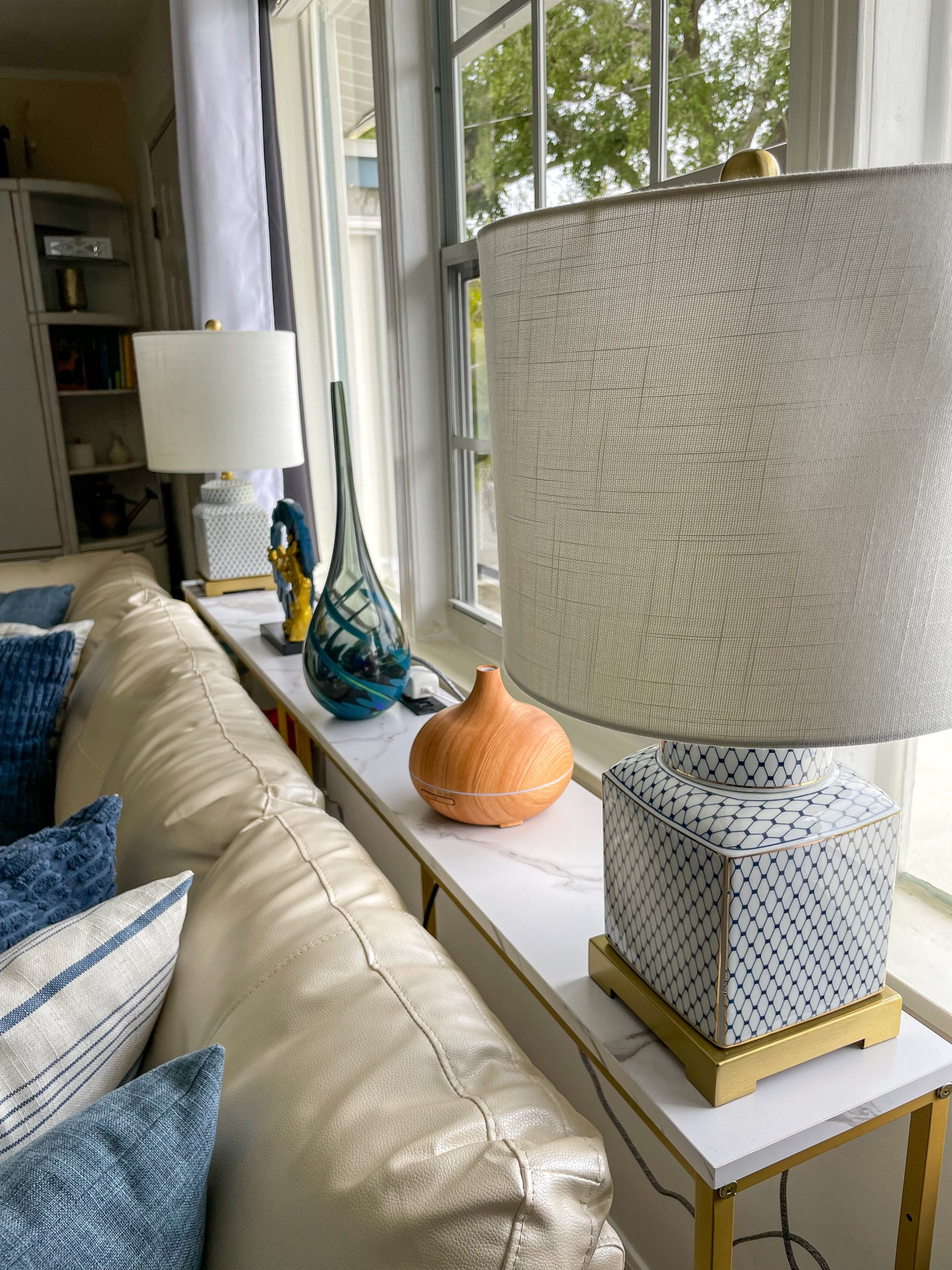 We placed this tall skinny table behind our coach and I can't believe I didn't have this idea before. We turned a dead space into an useful space that now hides the lamp cords. #amazonhome #founditonamazon

#LTKhome