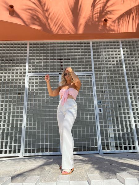 Pink bandeau tie front top, white tailored pants, Chloe slide sandals, Ray-Ban oval gold rimmed sunglasses, vacation outfit, Spring look

#LTKSeasonal #LTKshoecrush #LTKU