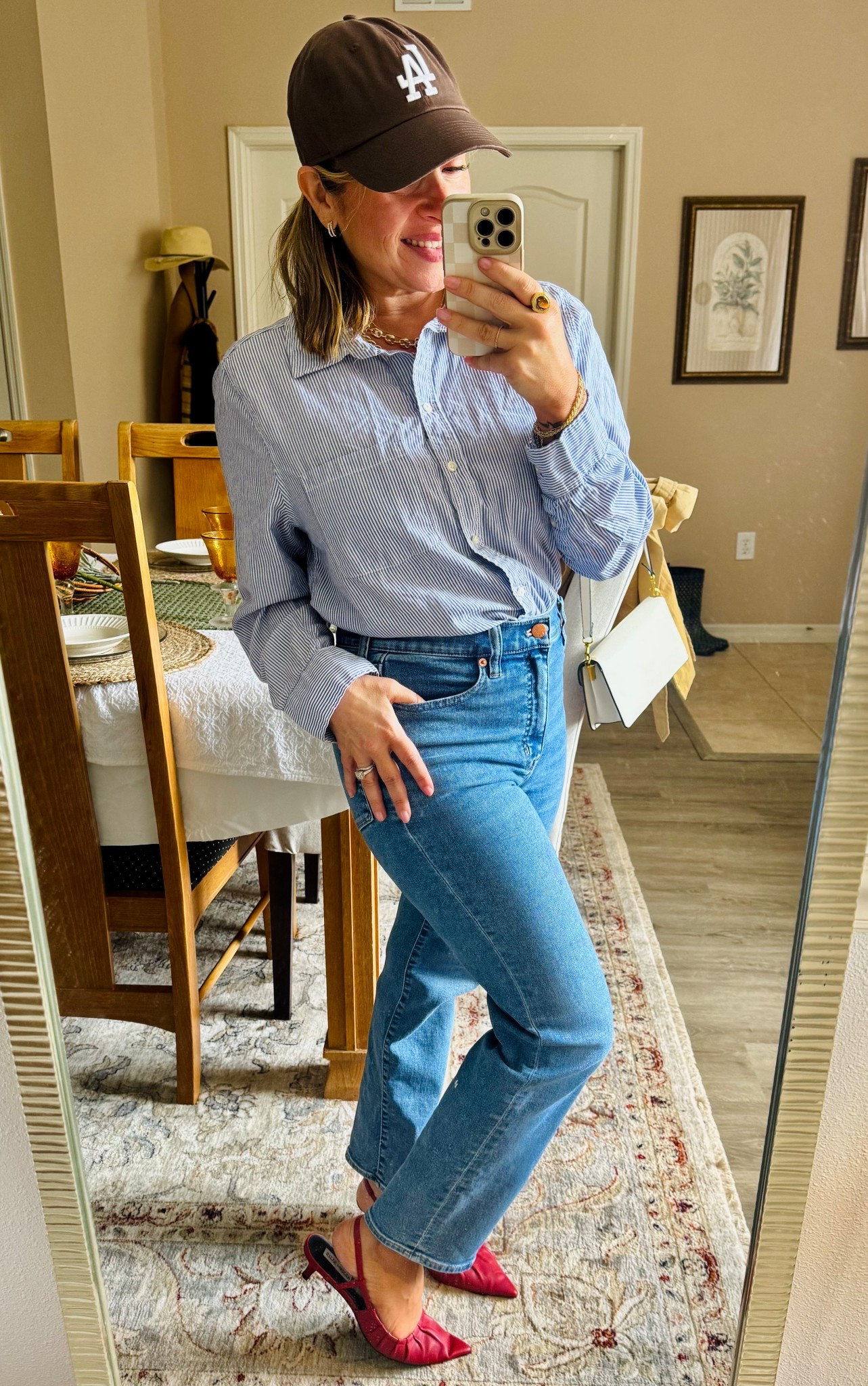 Without the Coat – Striped button-down + straight denim + baseball cap = effortless casual. The red slingbacks add the perfect pop of color so it still feels styled, not just thrown on.

#LTKPetite #LTKStyleTip #LTKSeasonal