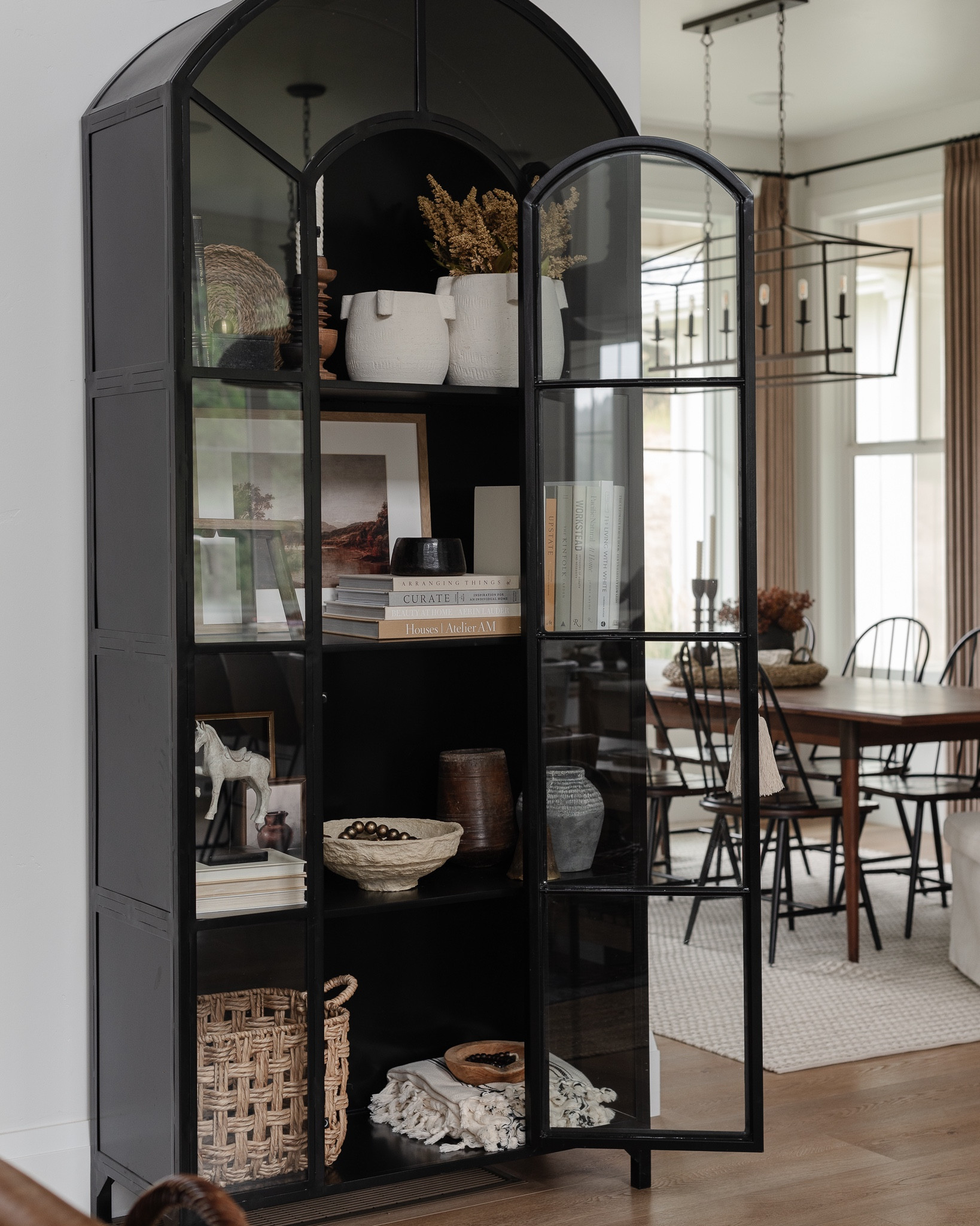 Shop the post! I restyled our black cabinet for fall and I’m loving it. Probably the best she’s ever looked! 🍂 

Cabinet, McGee and co, studio McGee, glass cabinet, arched cabinet, dining table, rug, amber Lewis, amber interiors, dining chair, shelf decor, home decor, fall, autumn, vase, candle holder, pot, basket 

#LTKunder100 #LTKhome #LTKsalealert