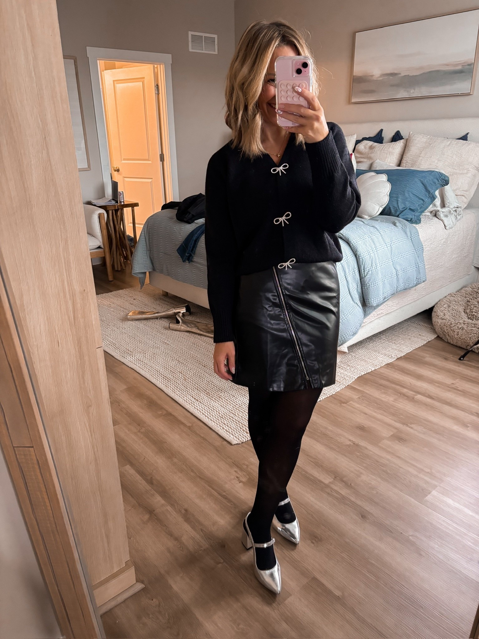A little bow detail meets a little leather moment.
This cardigan + faux leather skirt combo is the perfect mix of feminine and edgy — and so easy to dress up with tights and heels for the holidays or winter date nights.


Bow cardigan • faux leather skirt outfit • winter outfit inspo • petite friendly style
