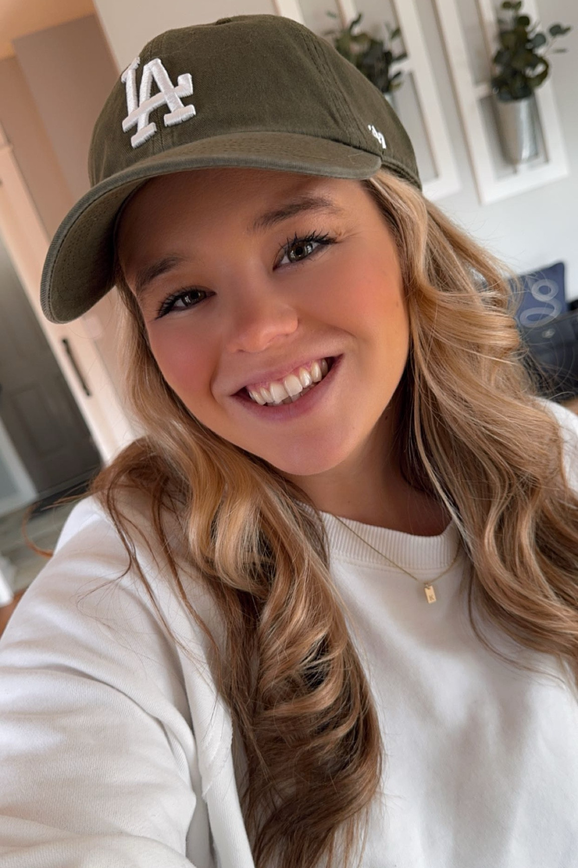 Cute sporty mom weekend look - soft fleece distressed white crewneck pullover sweatshirt - baseball cap for women - high rise black leggings with side leg pickets - new balance running sneakers - initial layering necklace 

#LTKFindsUnder50 #LTKMidsize #LTKFindsUnder100