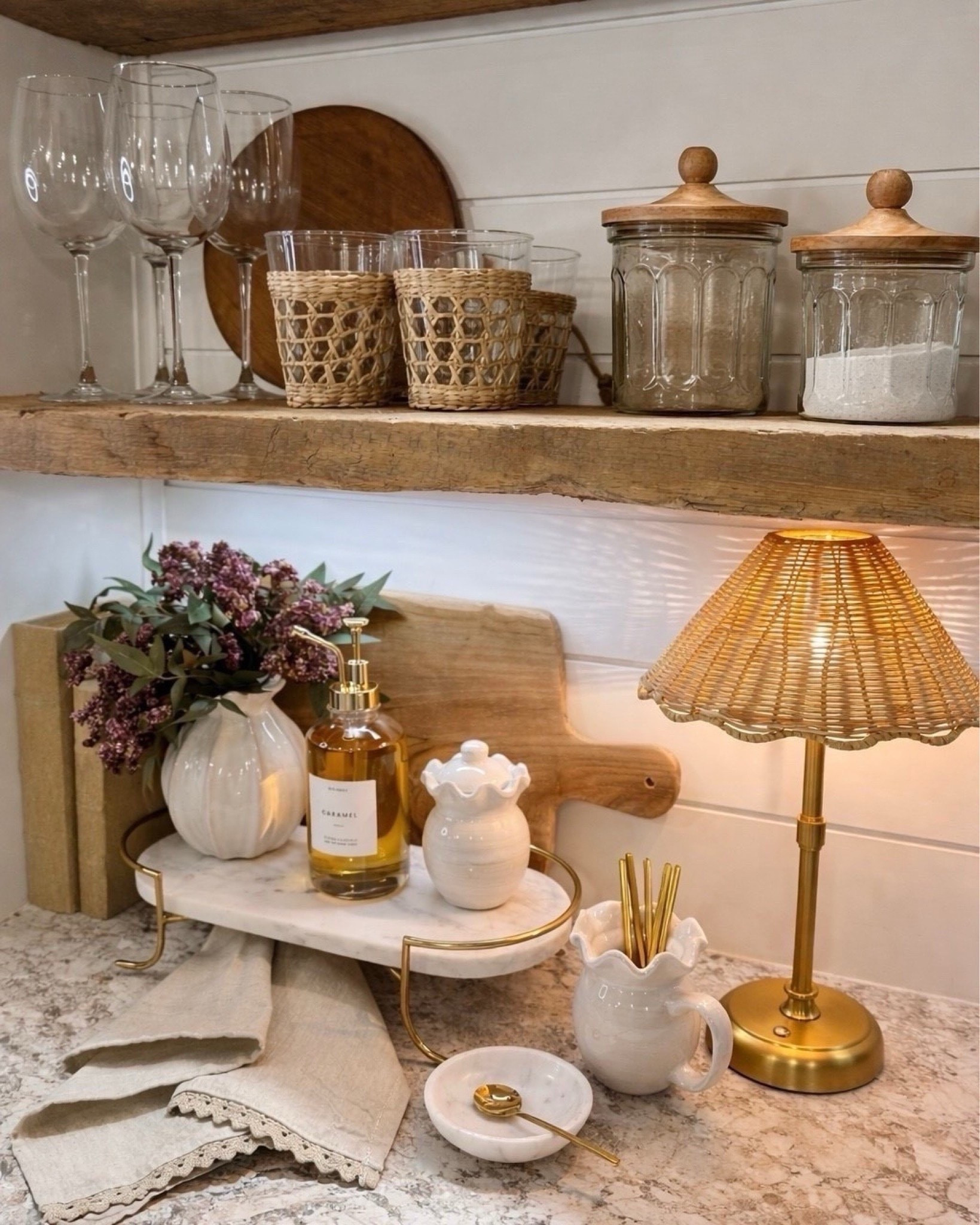 Cozy Counter Styling  Follow @farmtotablecreations on Instagram for more cozy home finds 🤍

Small details like this can completely change the feel of your kitchen without doing a full makeover. I layered a marble tray with everyday essentials like soap, a petite vase, and a cutting board for warmth, then added a rattan lamp for that soft, cozy glow. The glass canisters and woven cups on the wood shelf keep everything functional but still styled, making this corner feel both pretty and practical.

#kitchendecor #countertopdecor #kitchenstyling #neutraldecor #homedecor

#LTKHome #LTKSaleAlert